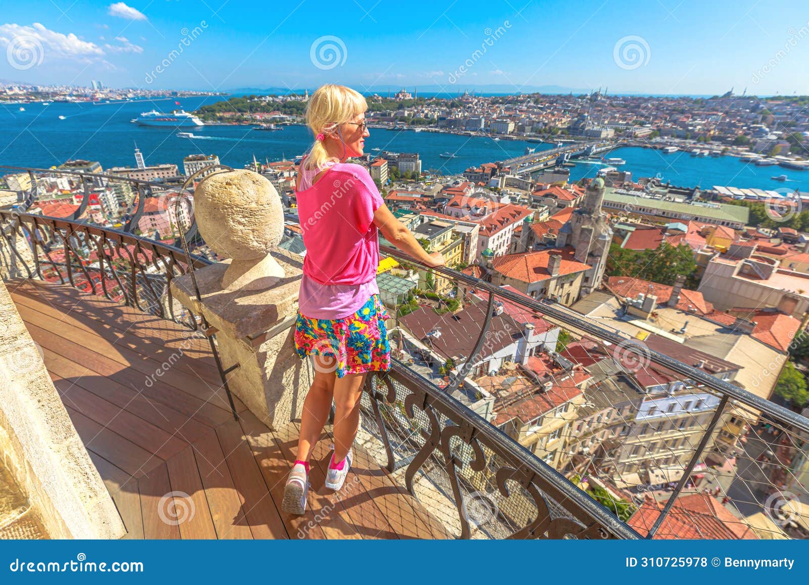 lady savoring the urban panorama from galata balcony