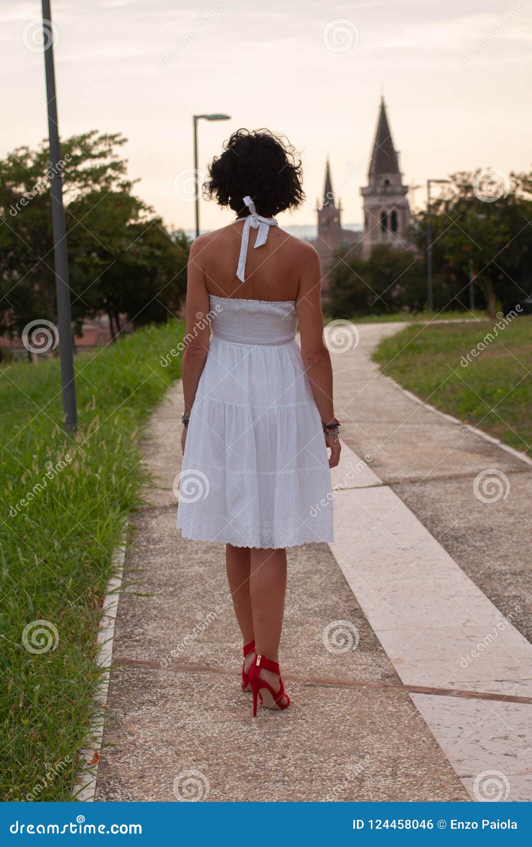 Lady with Short White Dress and Red Shoes with Heels Stock Photo