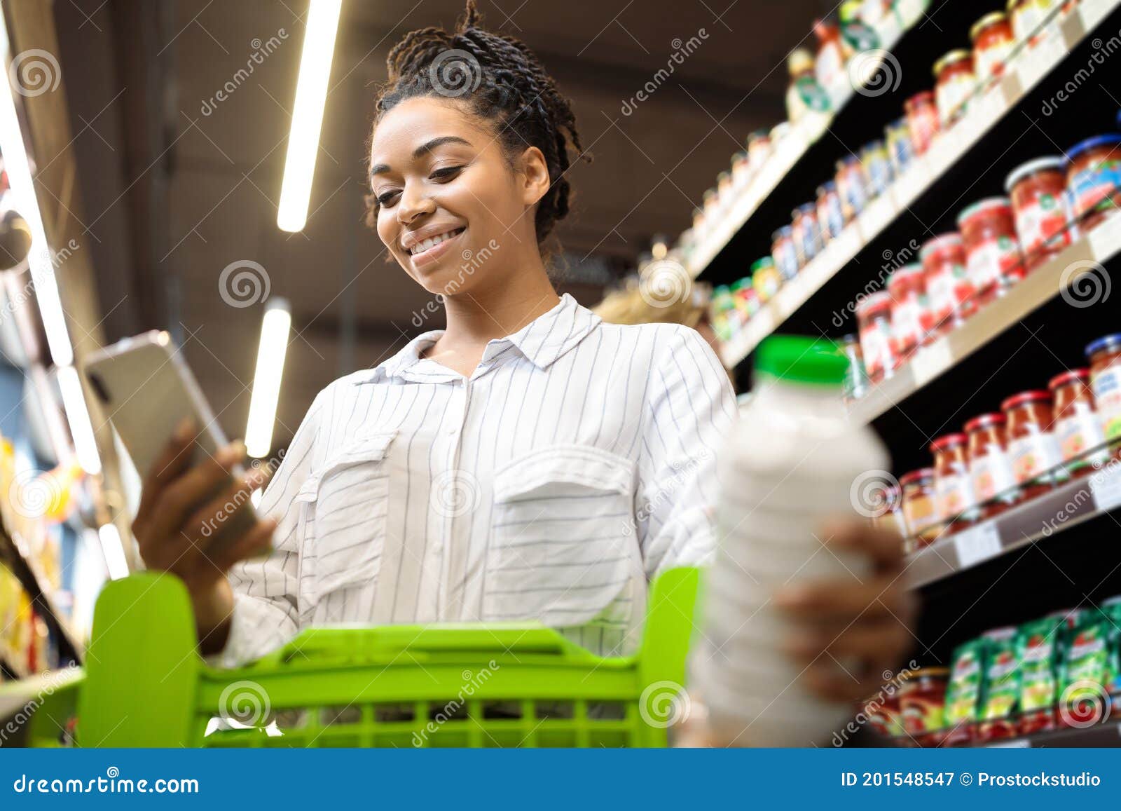 Lady Using Cellphone with Grocery Shopping Application in Supermarket ...
