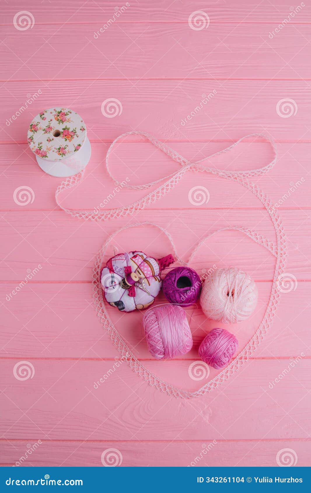 in the laid out lace heart are skeins of thread for knitting. s of openwork ribbon and threads are harmoniously
