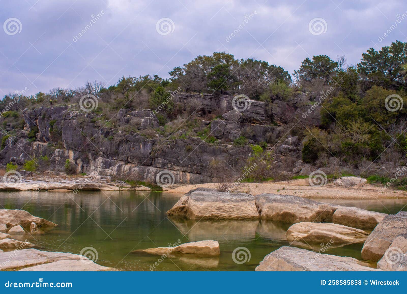 lake with big stones and rocks in the background, gunlom waterfall creek, australia