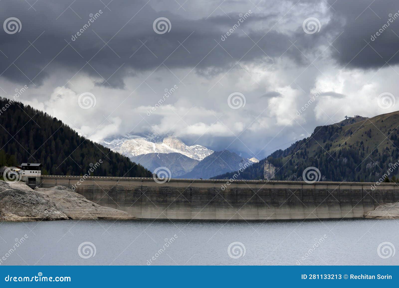 the dam of lago di fedaia, at the foot of the marmolada mountain. trento, itlay.