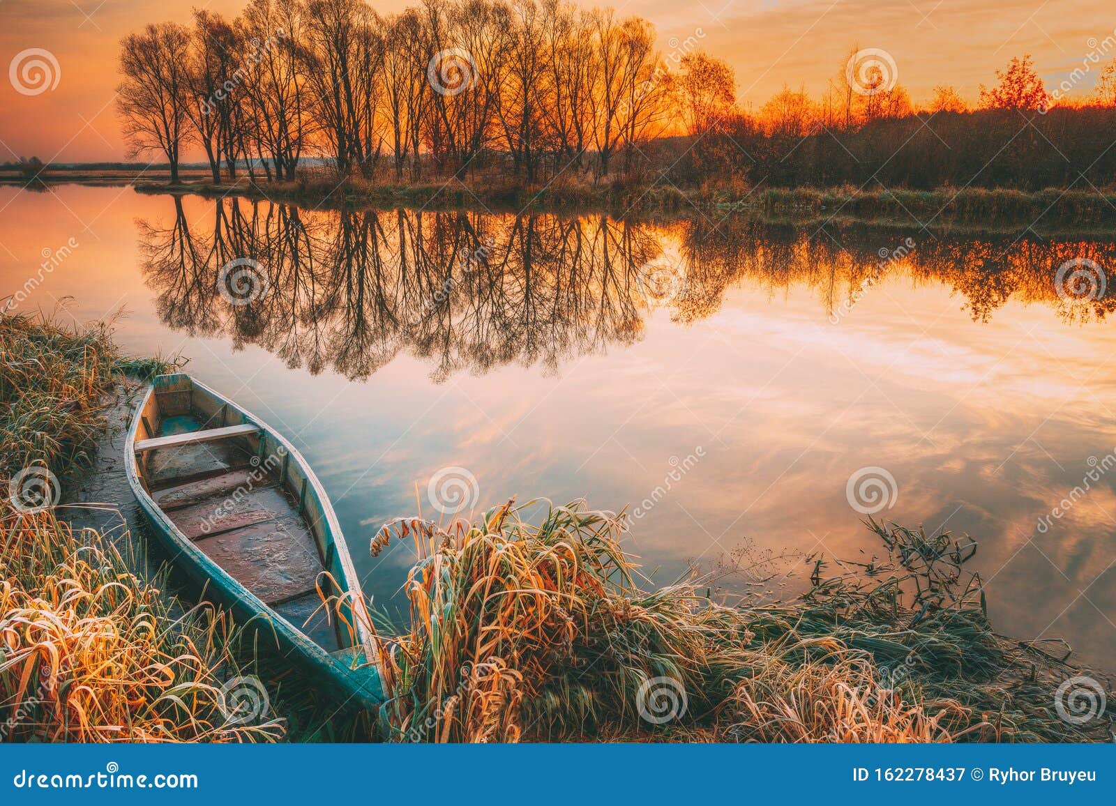 Lake River And Old Wooden Blue Rowing Fishing Boat At Beautiful Sunrise