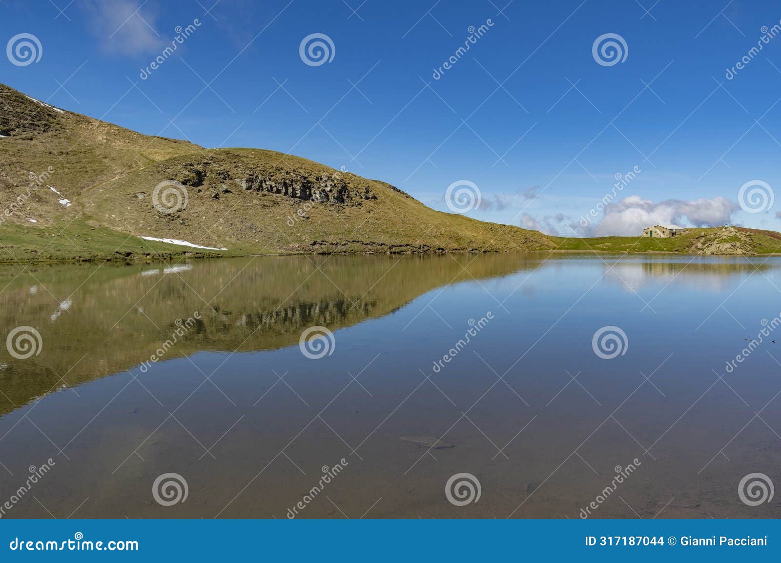 lake scaffaiolo and its reflections in may
