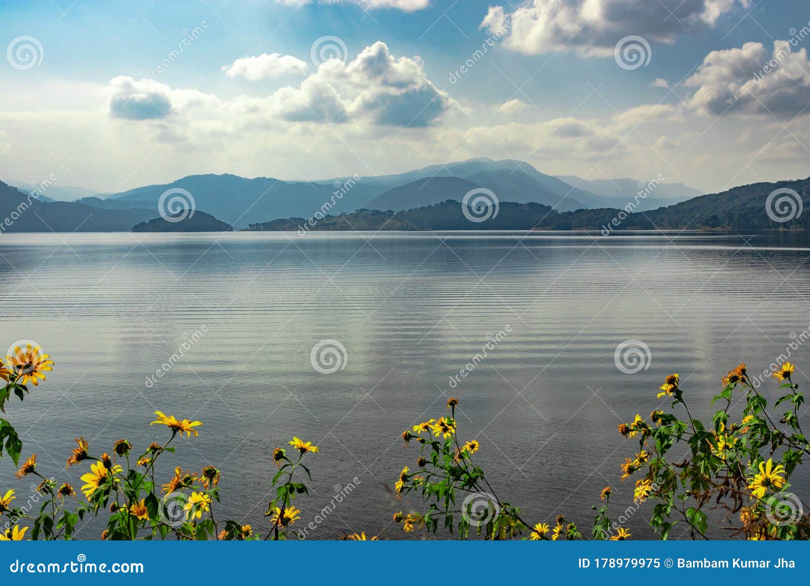 lake serene blue water with misty mountains and clouds reflections