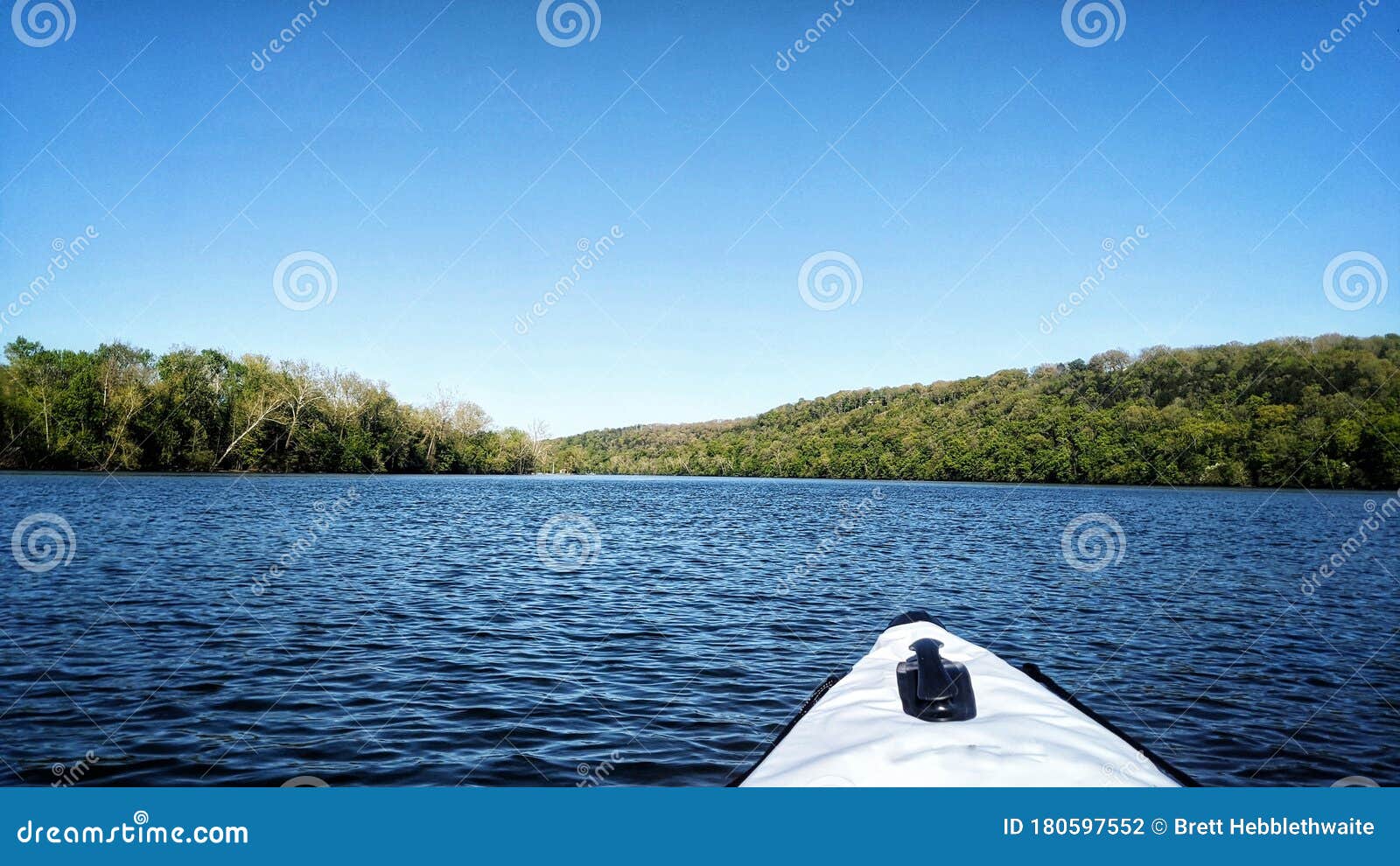 lake taneycomo on a kayak. blue skies and blue water.