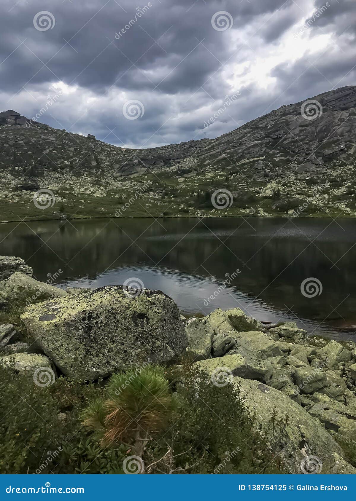 lake view with cloudy sky and mountain in siberia