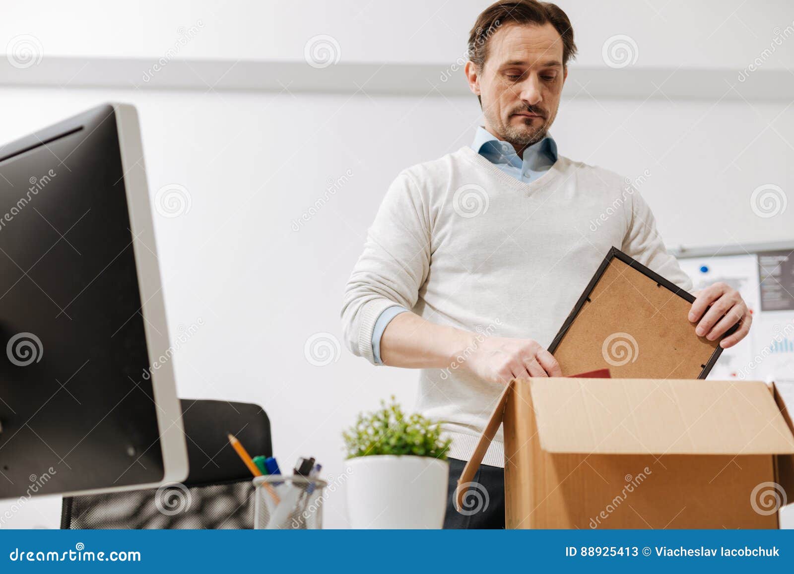 Некомпетентный сотрудник. Запакованный сотрудник. Грустный работник офиса. Офисный работник упаковывает товар. Мужчина кладет ноутбук в сумку фото.