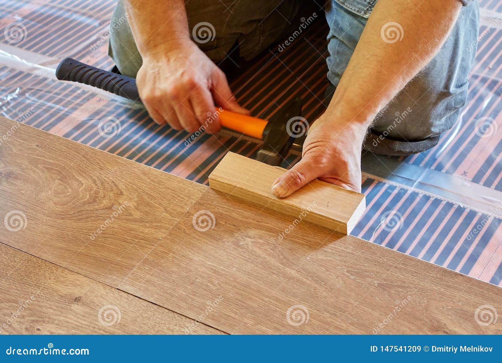 Laying Laminate Covering On Heat Insulated Floor Stock Image