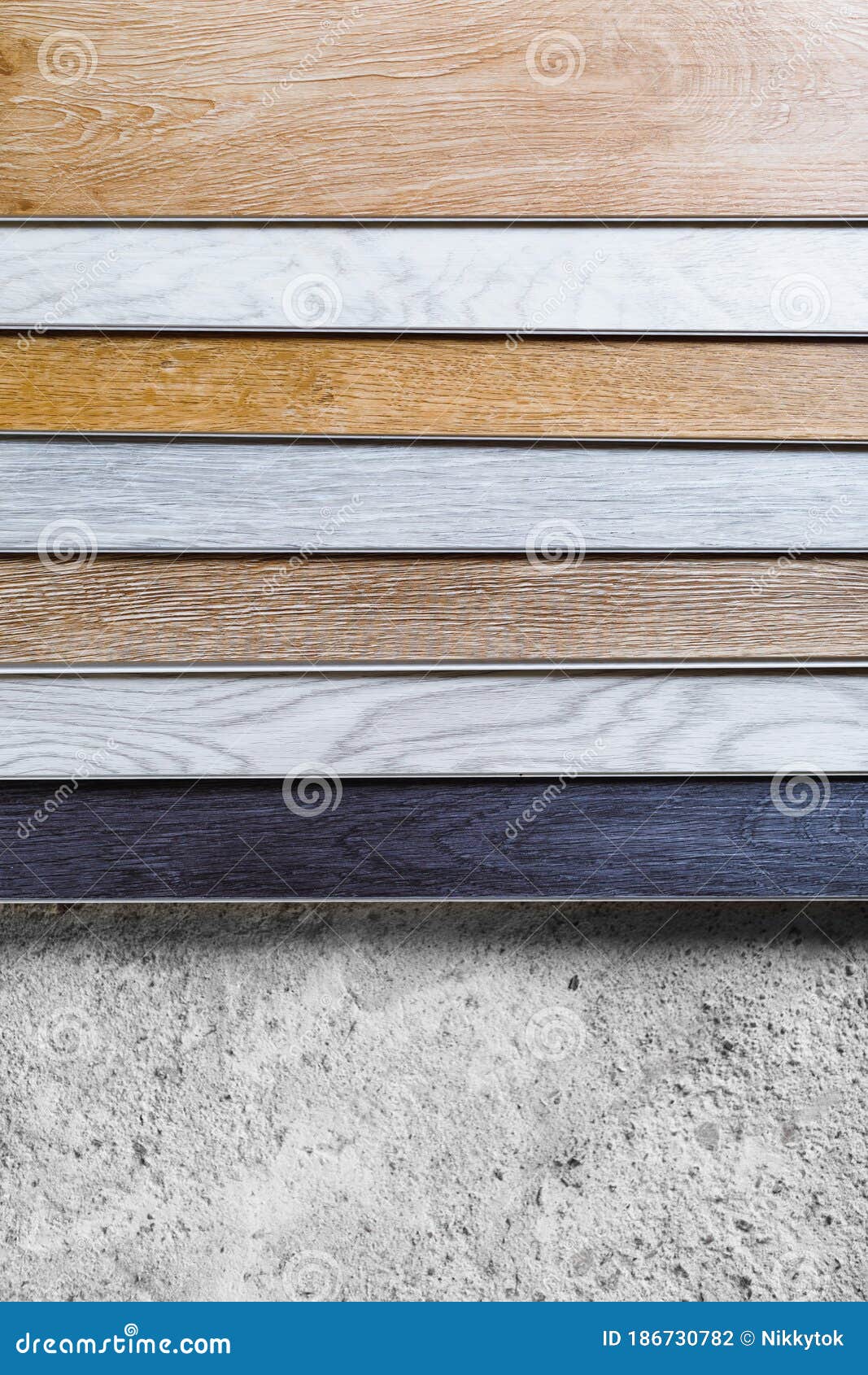 Laminate Flooring Planks Variations on Concrete Floor Stock Photo