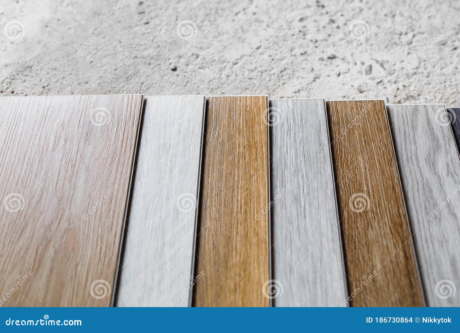 Laminate Flooring Planks Variations on Concrete Floor Stock Photo