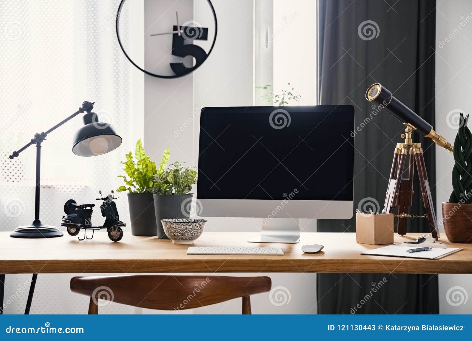 lamp and desktop computer on wooden desk in modern freelancer`s