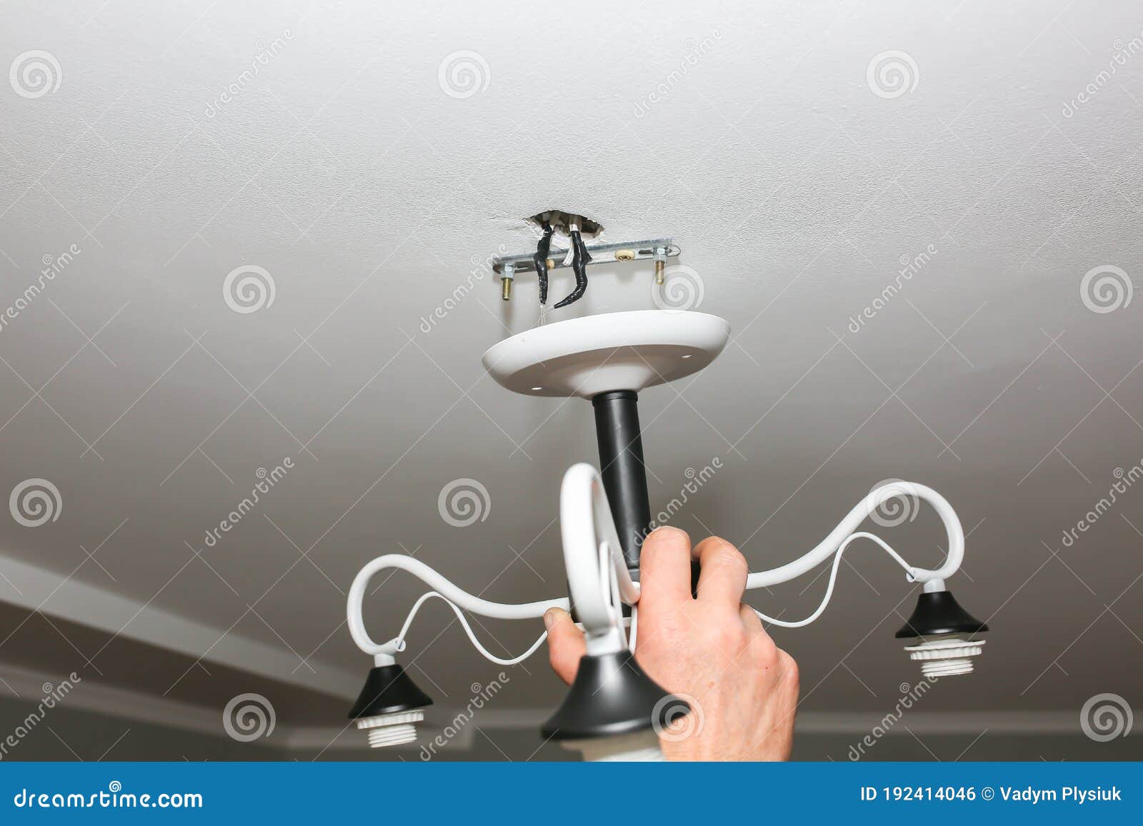 Lamp Installation. Man Holding Construction. Restoration Indoors