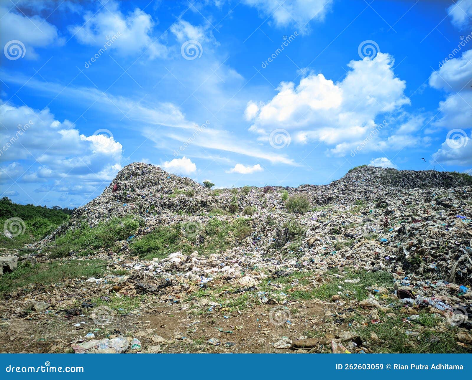 Landfill with Tons of Waste and Rubrish with the Blue Sky Stock Image