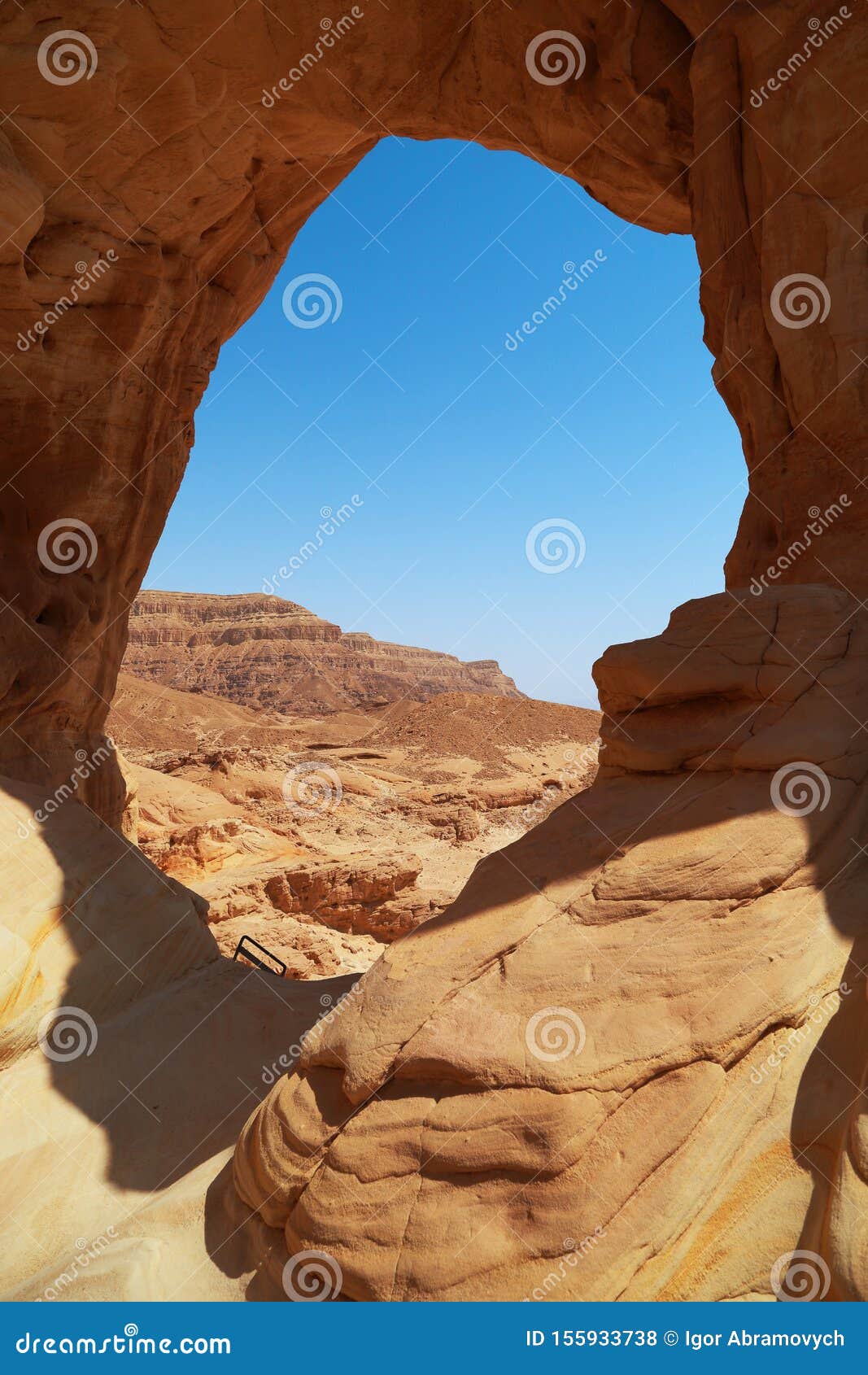 arava desert landscape through an erosive stone window in a rock, israel