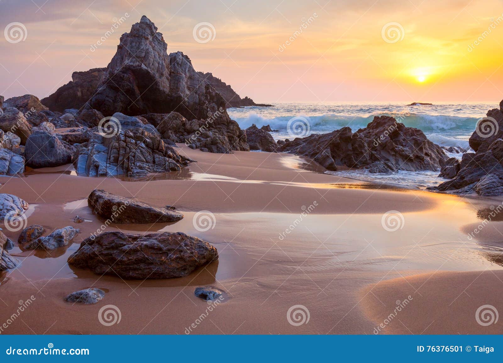 landscape of big rocks the ocean beach at sundown