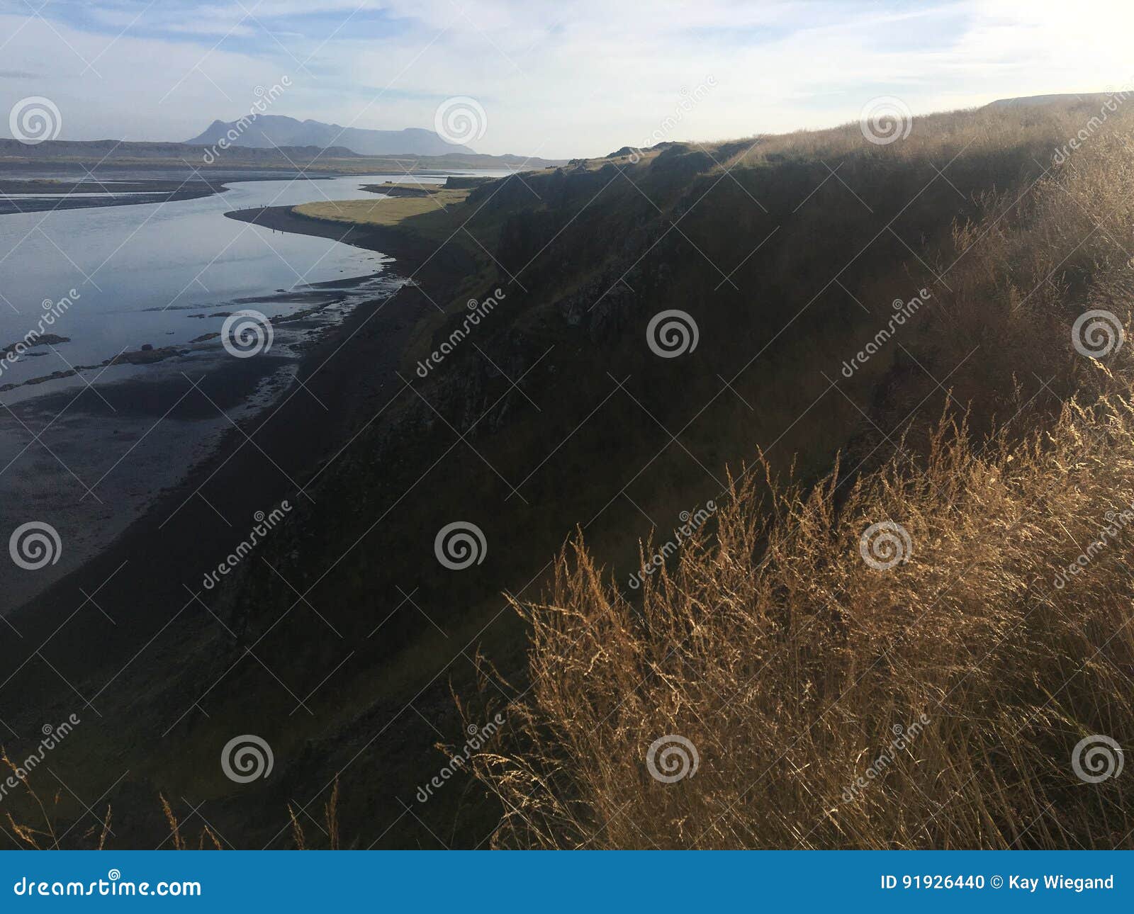 Landscape With Cliff And Mountain Range At The Ocean Light Reflections