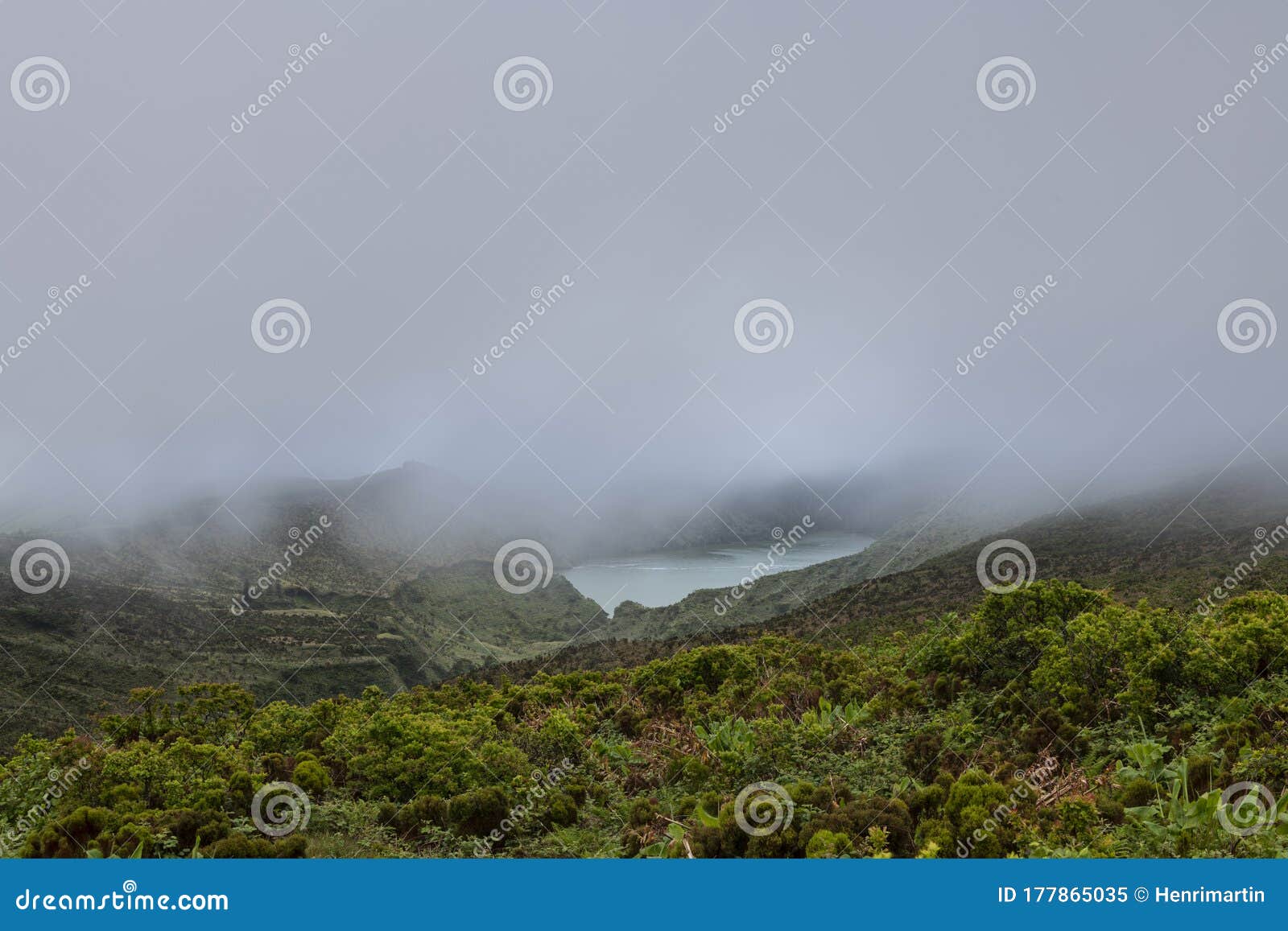 landscape of low clouds and bad weather over lagoa funda das lajes caldera volcanic crater lake at ilha das flores island in the