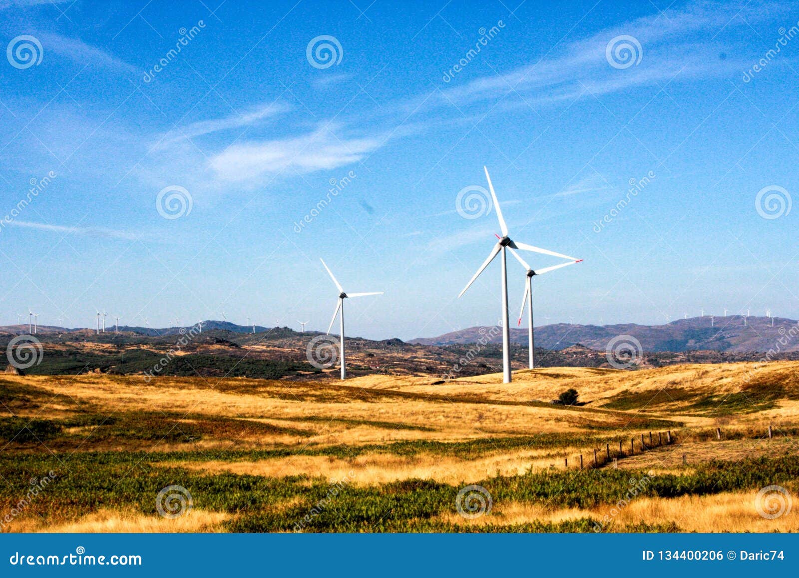 wind turbines on hilly expanse create energy, portugal europe