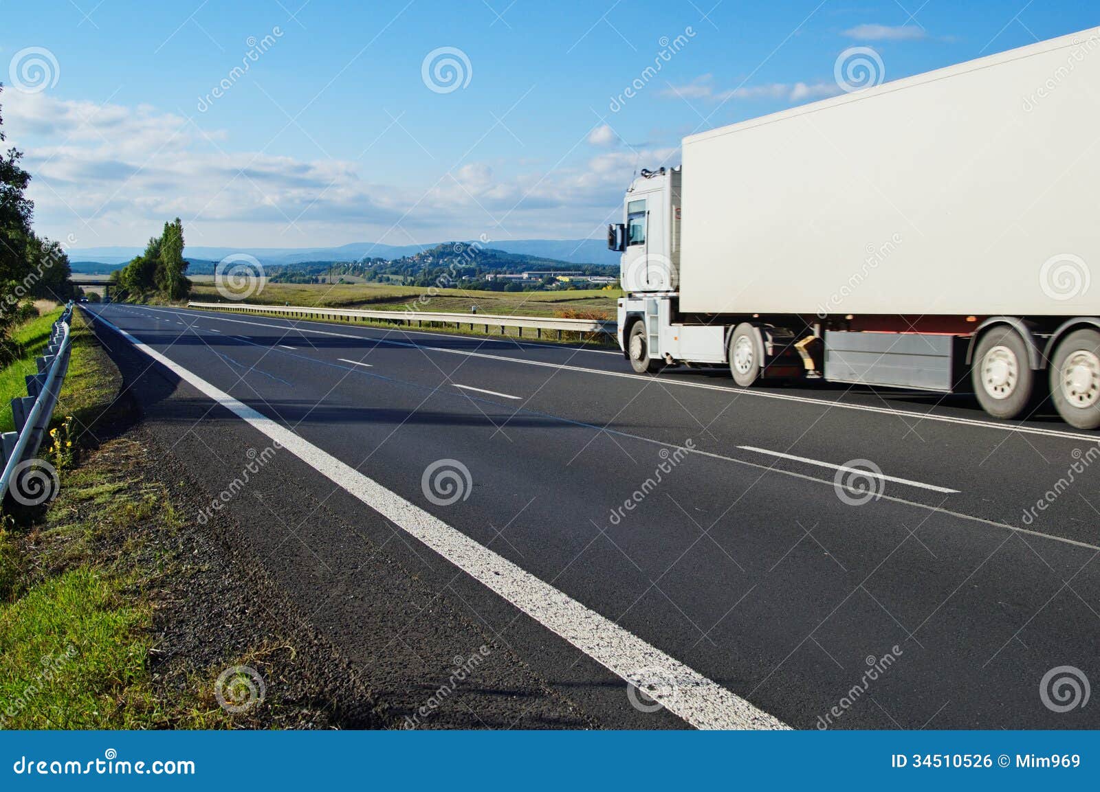 Landscape with road and truck. Landscape with road, the road goes white truck, in the distance a mountain and village