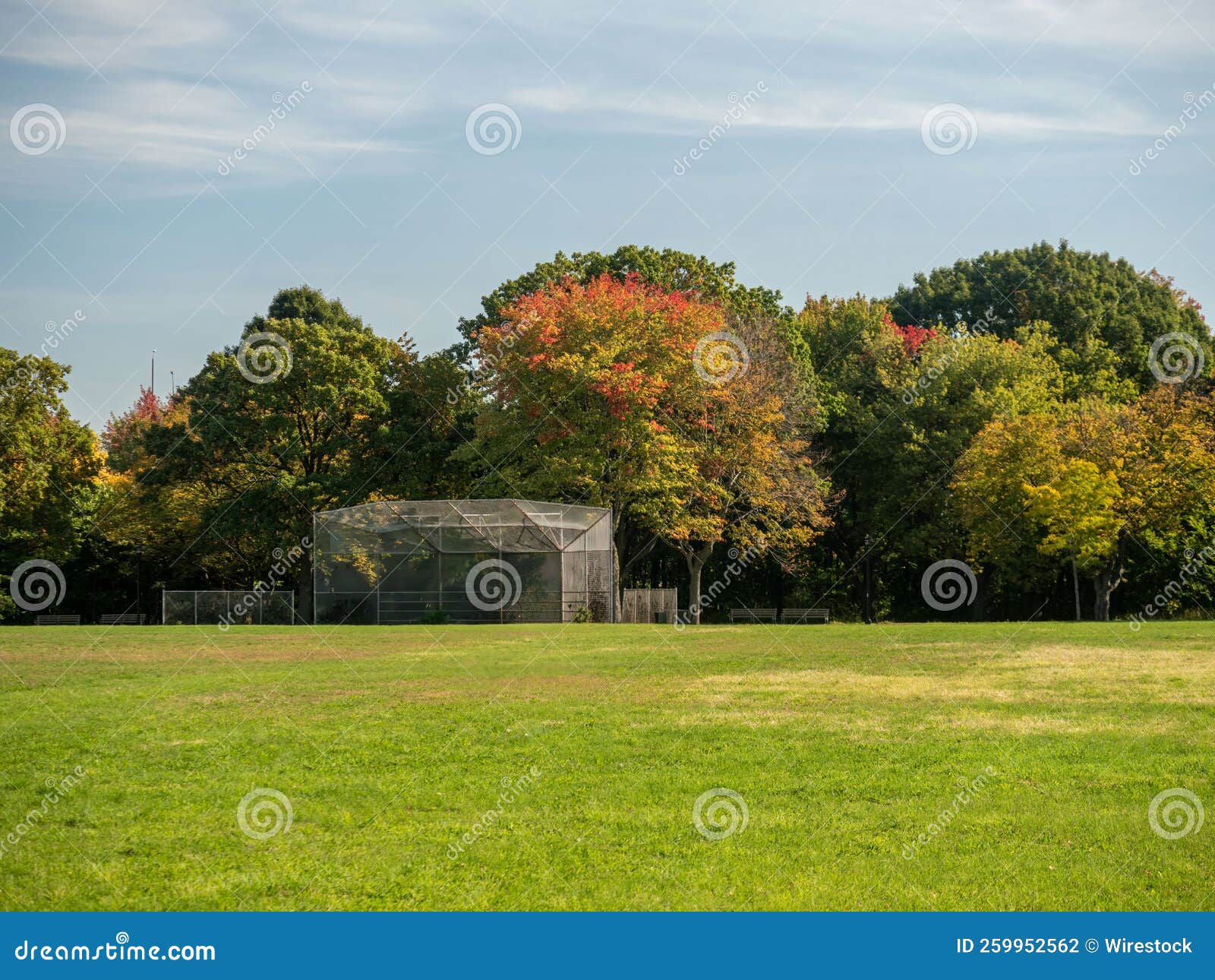 Landscape Shot of a Beautiful Park with Chain Link Backstop Under the