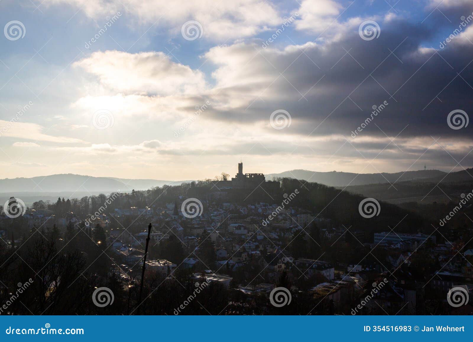 landscape shot in the evening at sunset. view of the castle and over a village in winter kÃ¶nigstein, taunus, hesse, germany