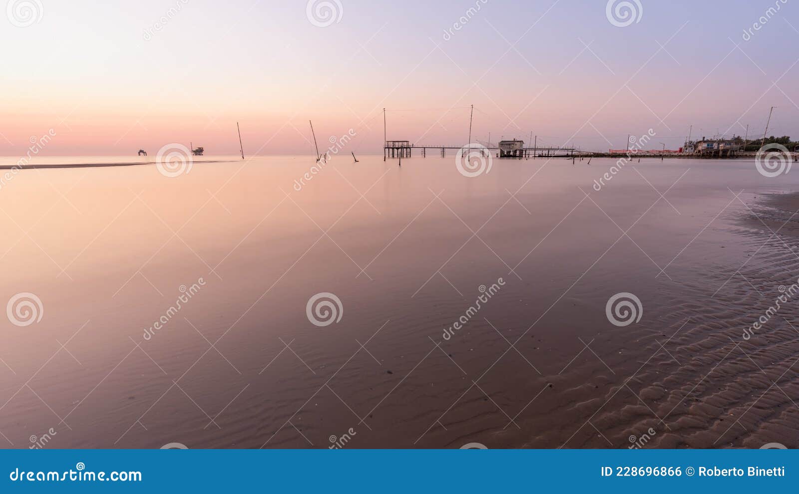 landscape view of fishing huts at sunrise