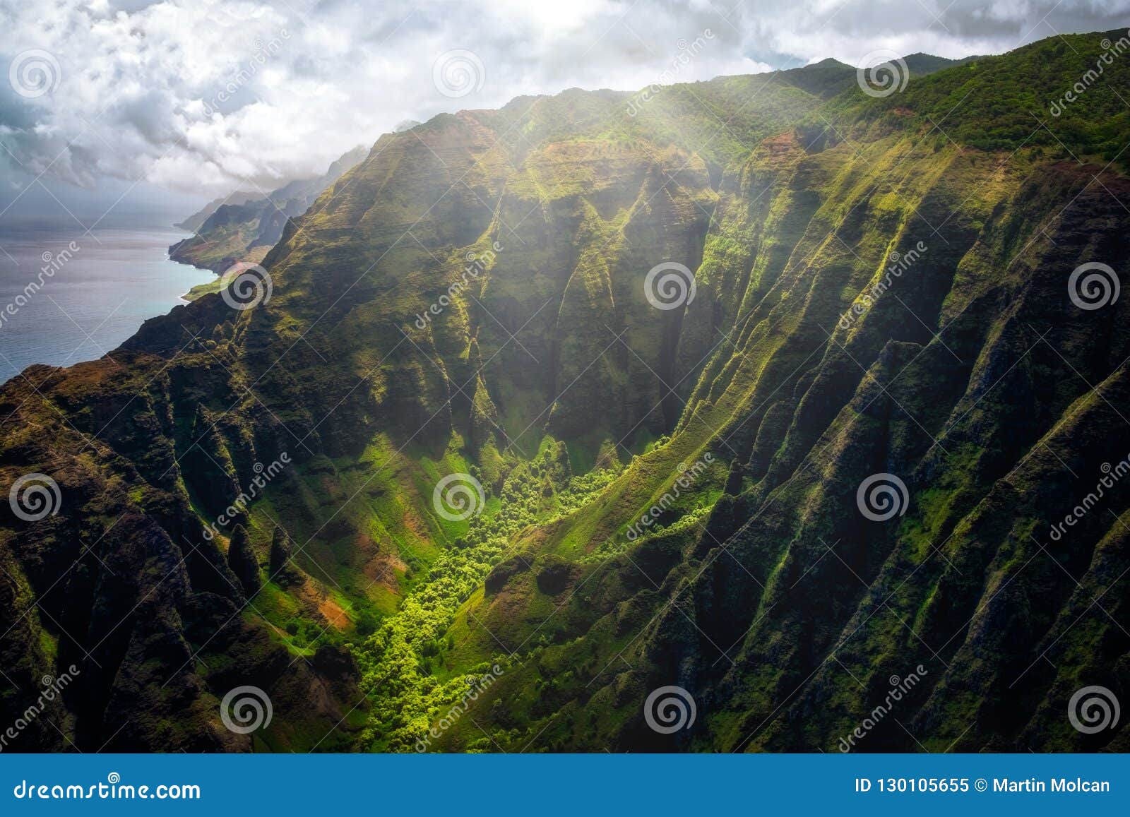 landscape view of na pali coastline cliffs with sunlight glow, kauai, hawaii