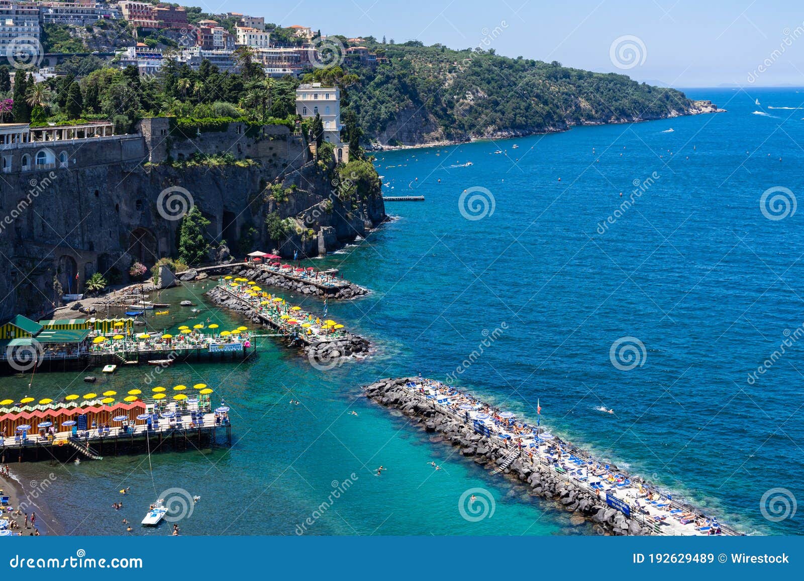 landscape of villa comunale surrounded by the sea under the sunlight in sorrento, italy