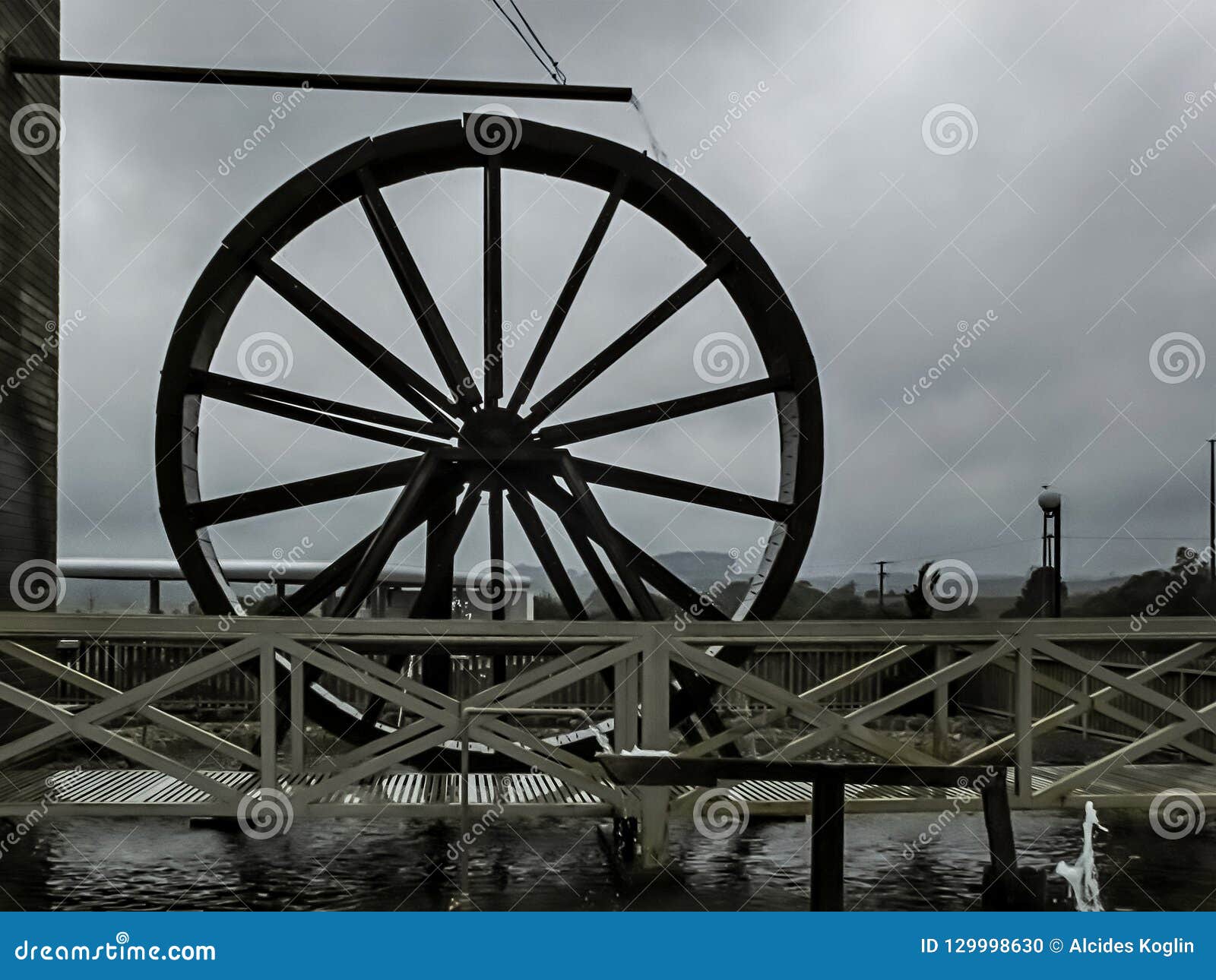 Landscape with Waterdriven Wheel in Front of a Bridge Stock Photo