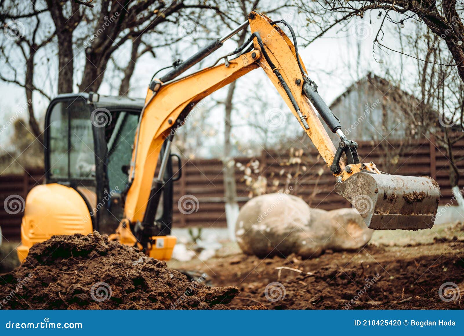 landscaping works with mini excavator at home construction site. terrain works