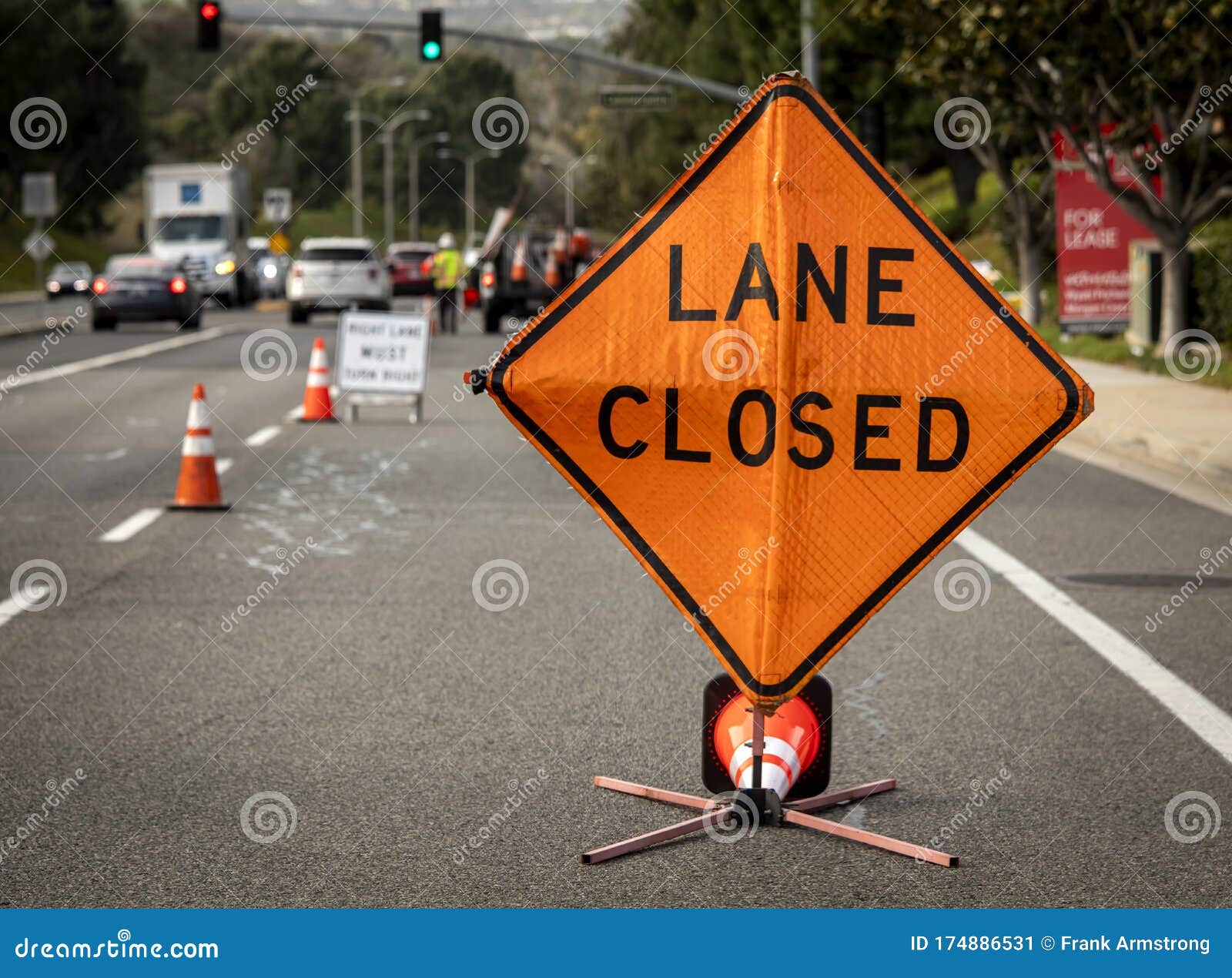Lane Closed Orange Diamond Shaped Sign with Work Crew in Distance Stock Image Image of delay