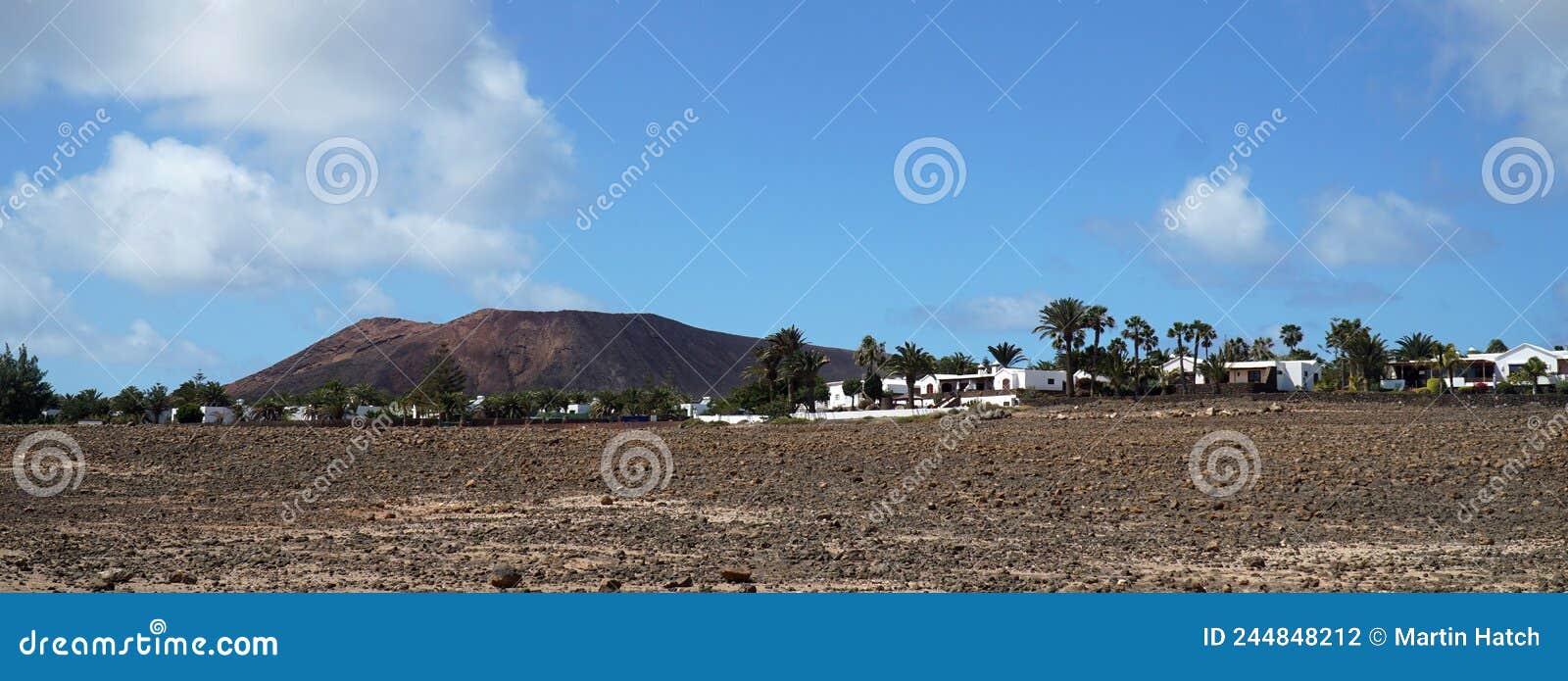 Lanzarote Landscape with Villas Mountain and Blue Sky Stock Photo