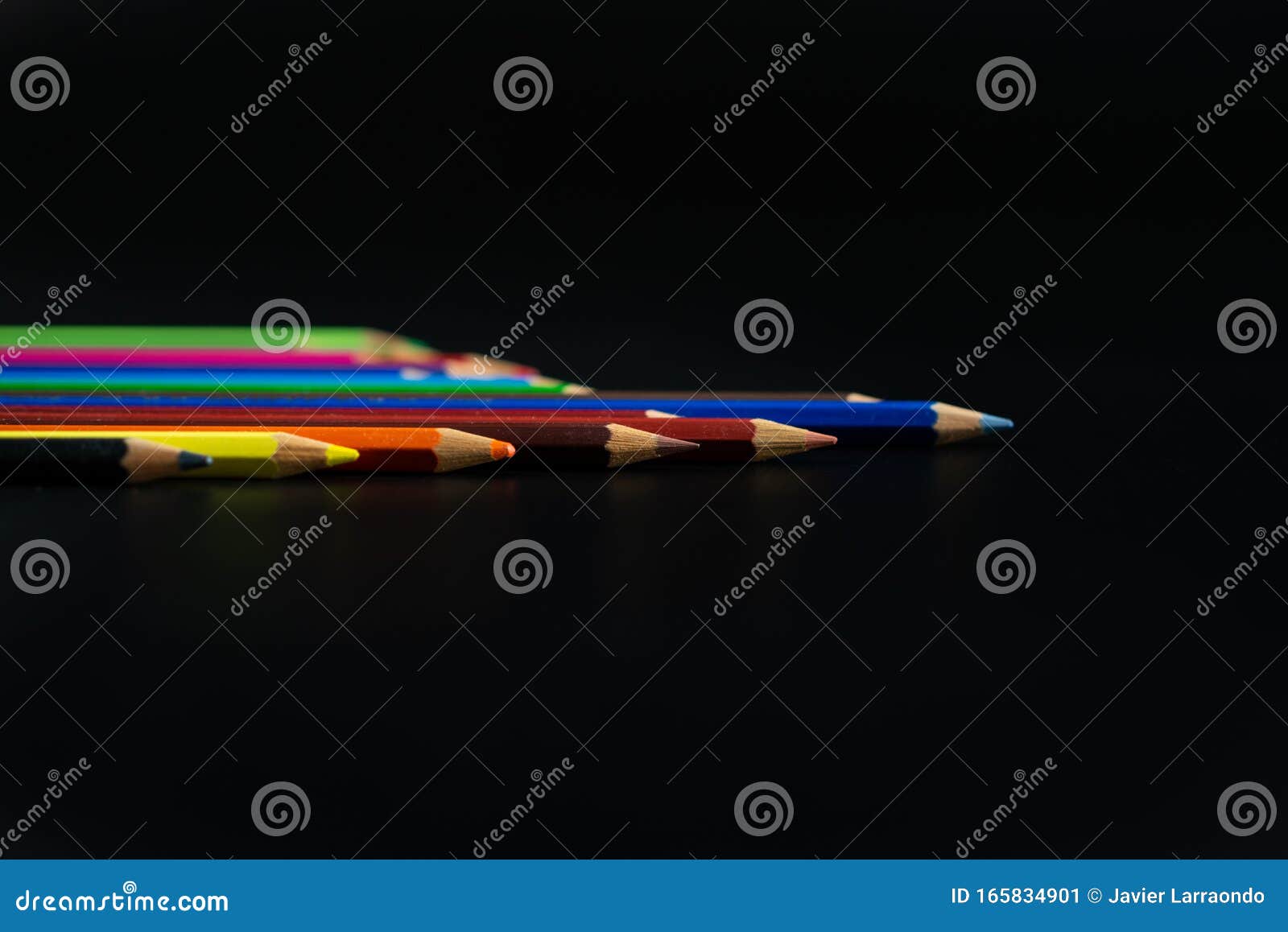 group of various colored pencils in black background