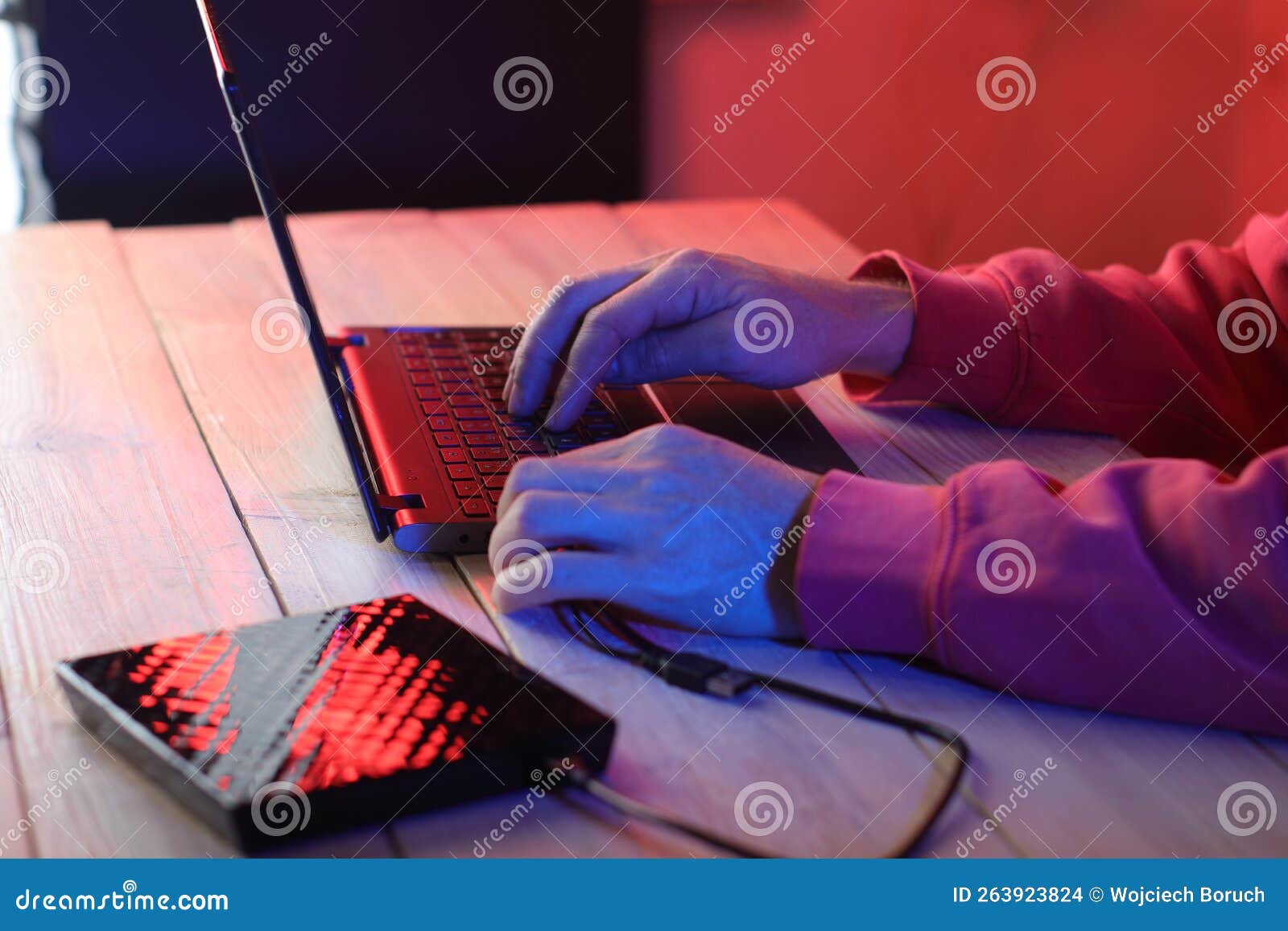 Laptop With Attached Optical Drive On The Table In Front Of A Person laptop-with-attached-optical-drive-on-the-table-in-front-of-a-person