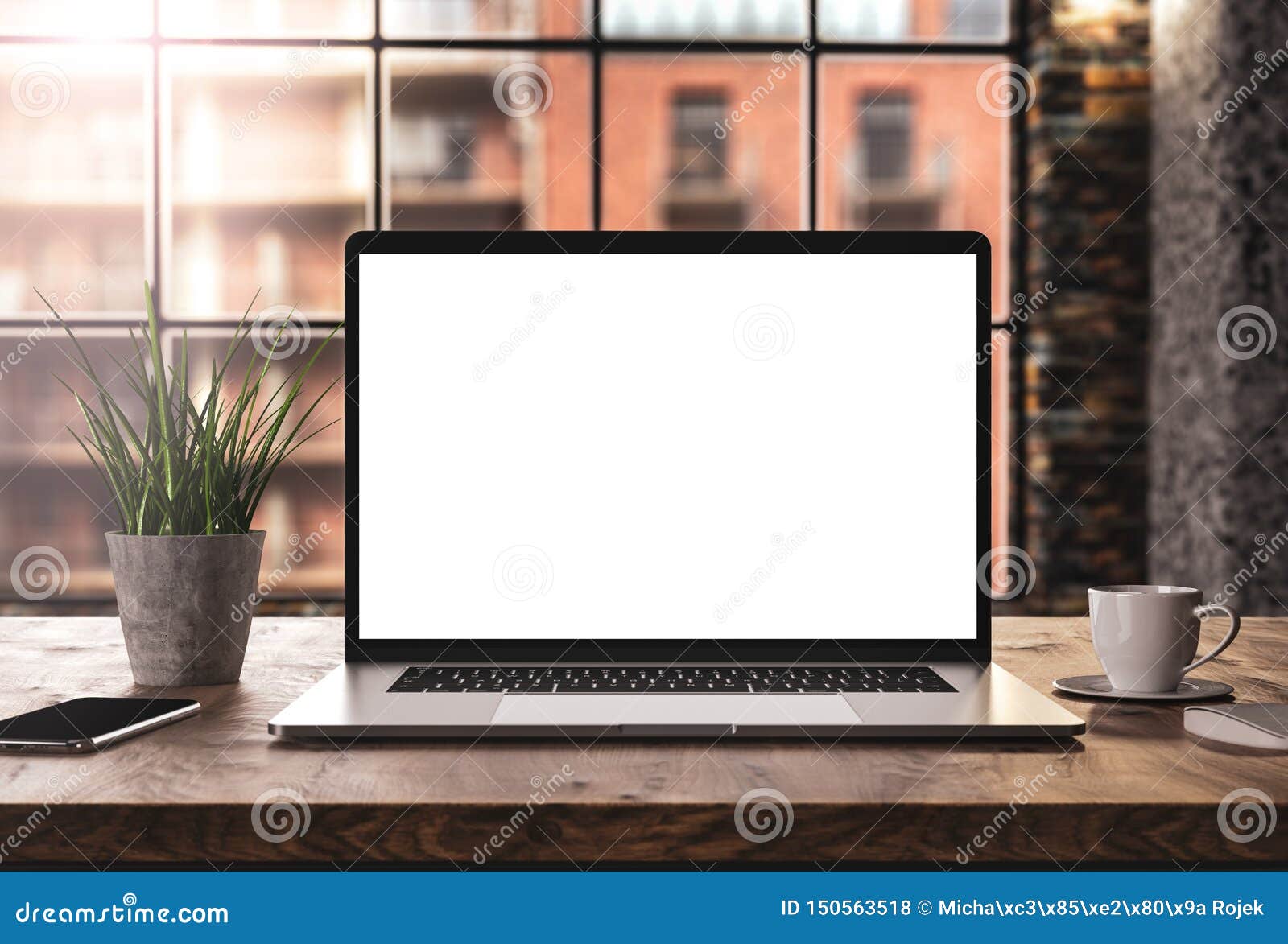 laptop with blank screen mockup template on table in industrial old factory loft interior