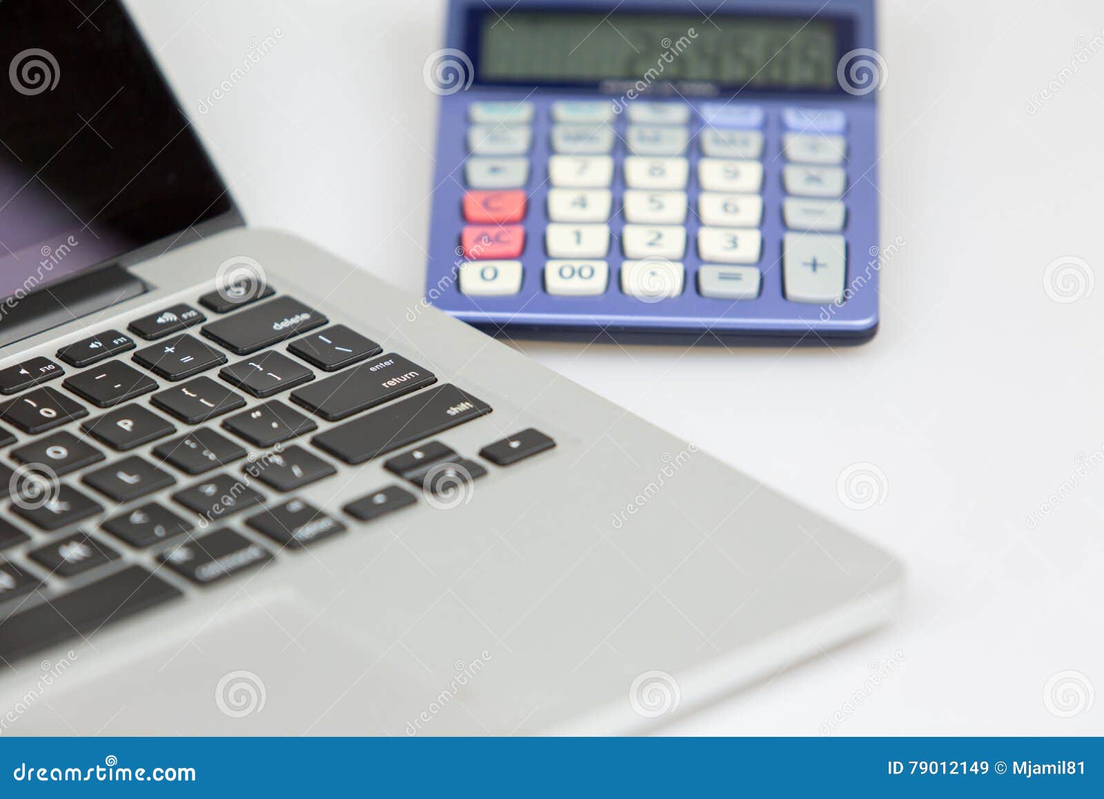 Laptop and calculator editorial stock image. Image of investment 79012149