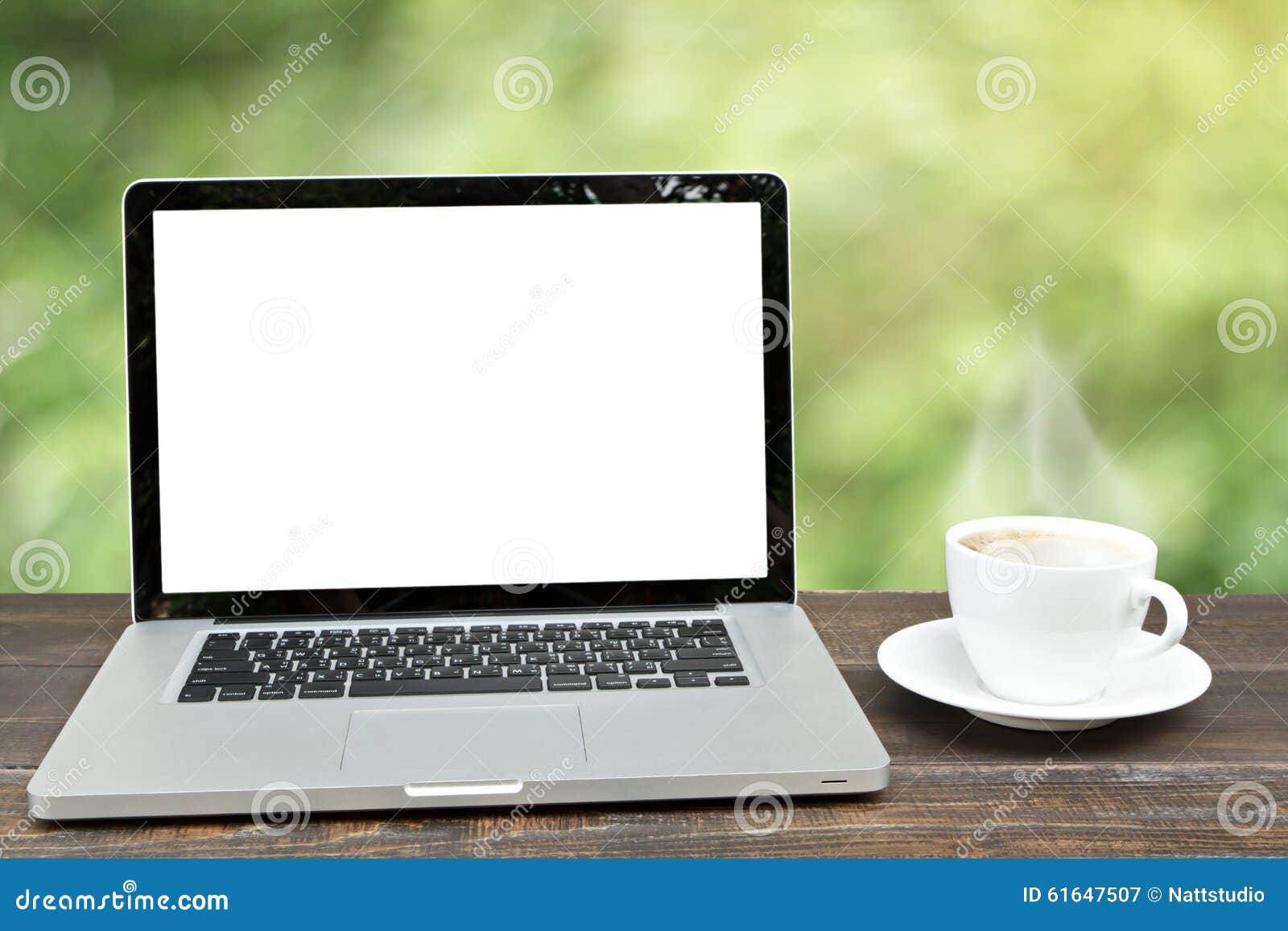 laptop computer with coffee cup on wooden with defocus of garde