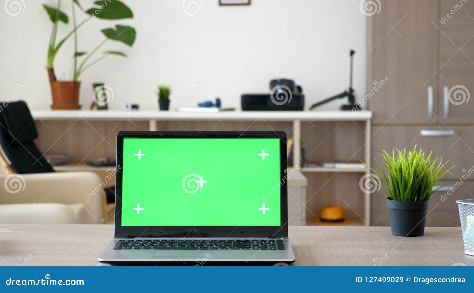 Laptop Computer With Green Screen Mock Up On A Desk In The Middle
