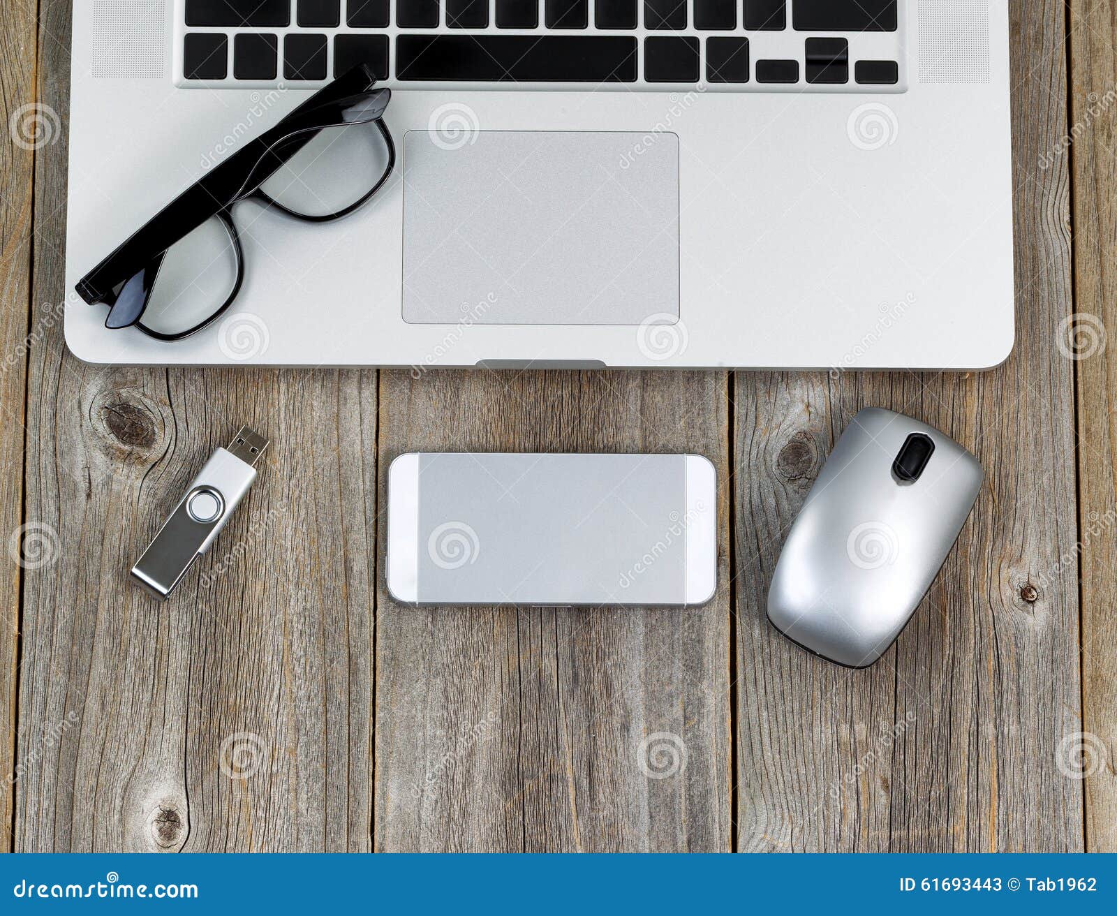 Laptop Computer With Peripherals And Reading Glasses On Rustic W Stock