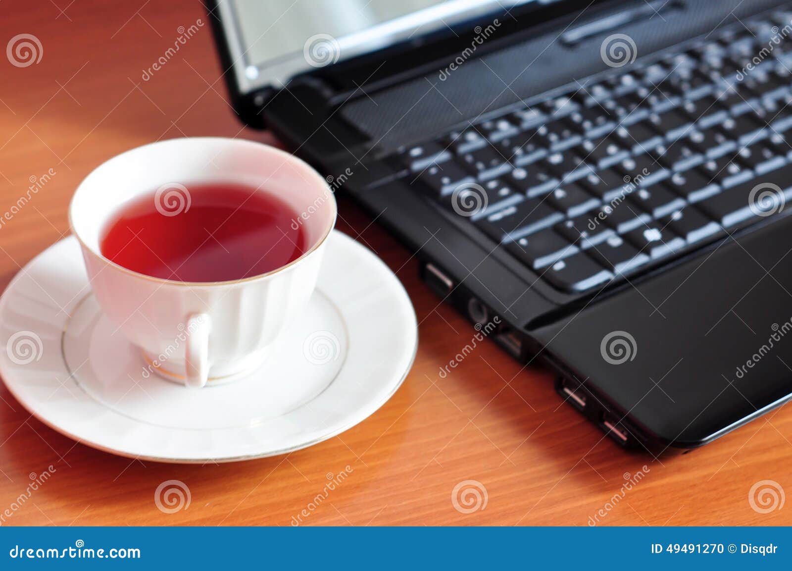 Laptop and a cup of tea stock photo. Image of business 49491270