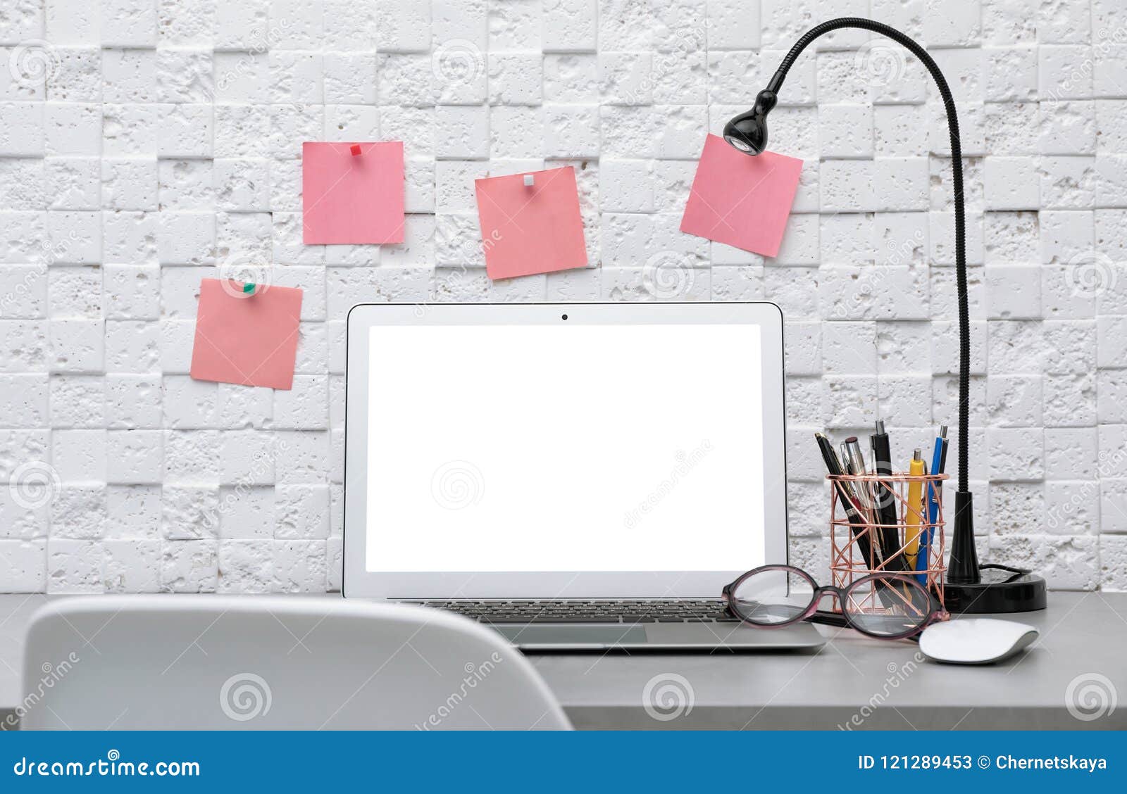 Laptop On Desk Against Light Wall In Home Office Stock Image