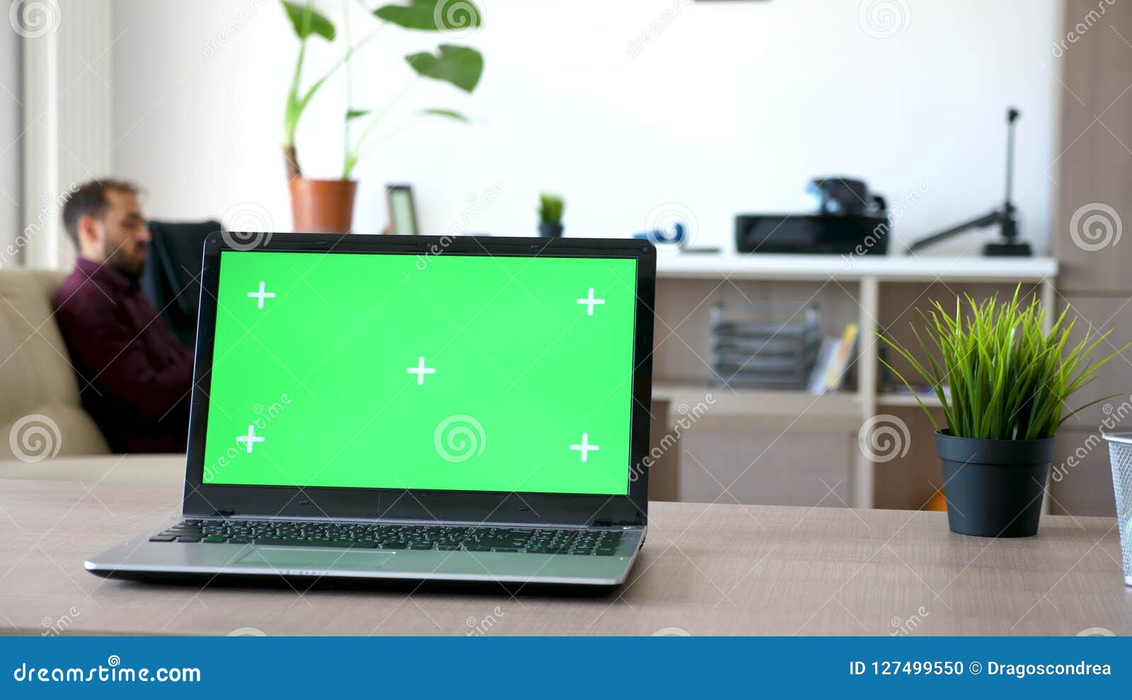 Laptop On A Desk In The Living Room With A Isolated Green Screen