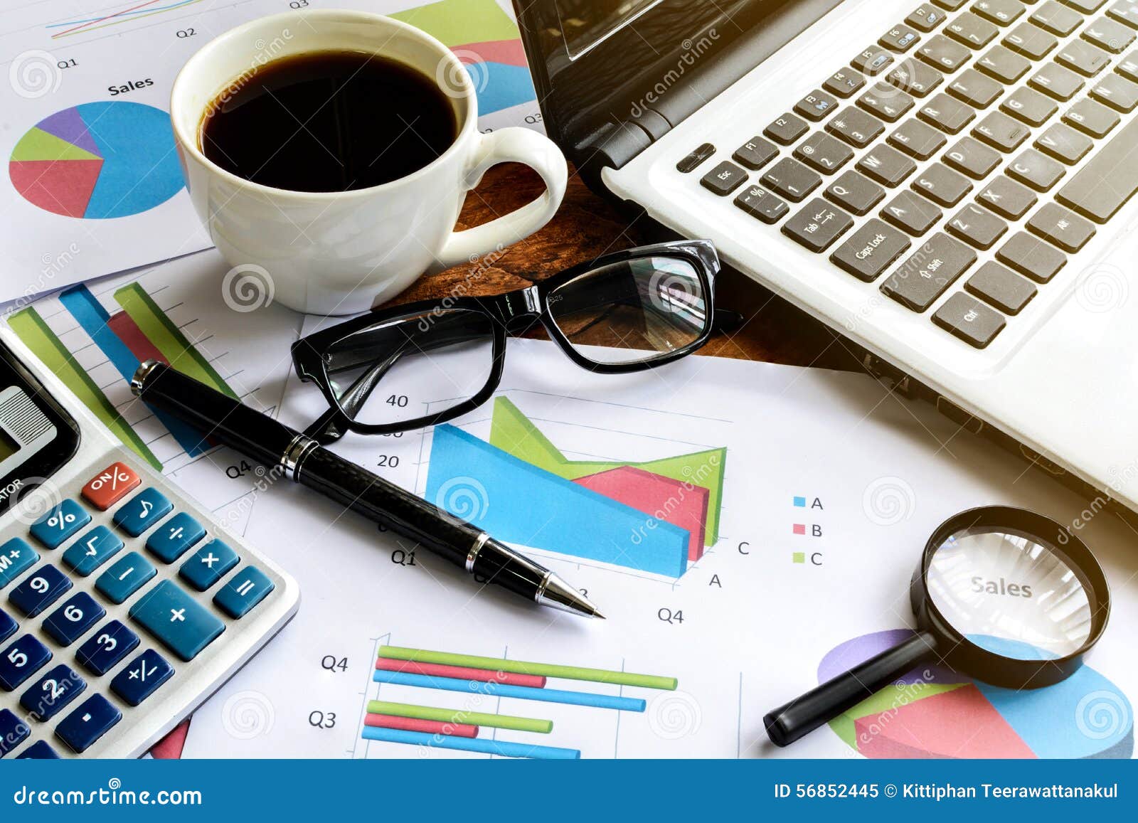 Laptop on Desk Office and Graph Analysis Spreadsheet Stock Image