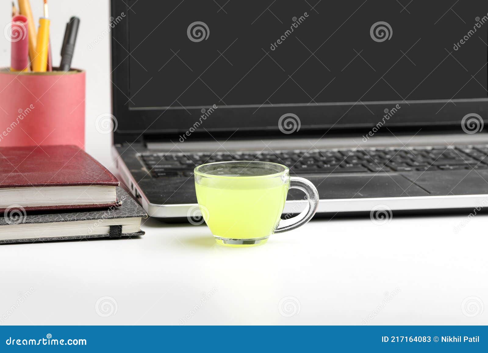 Laptop and Diary with Cup of Green Tea. Work from Home Concept Stock