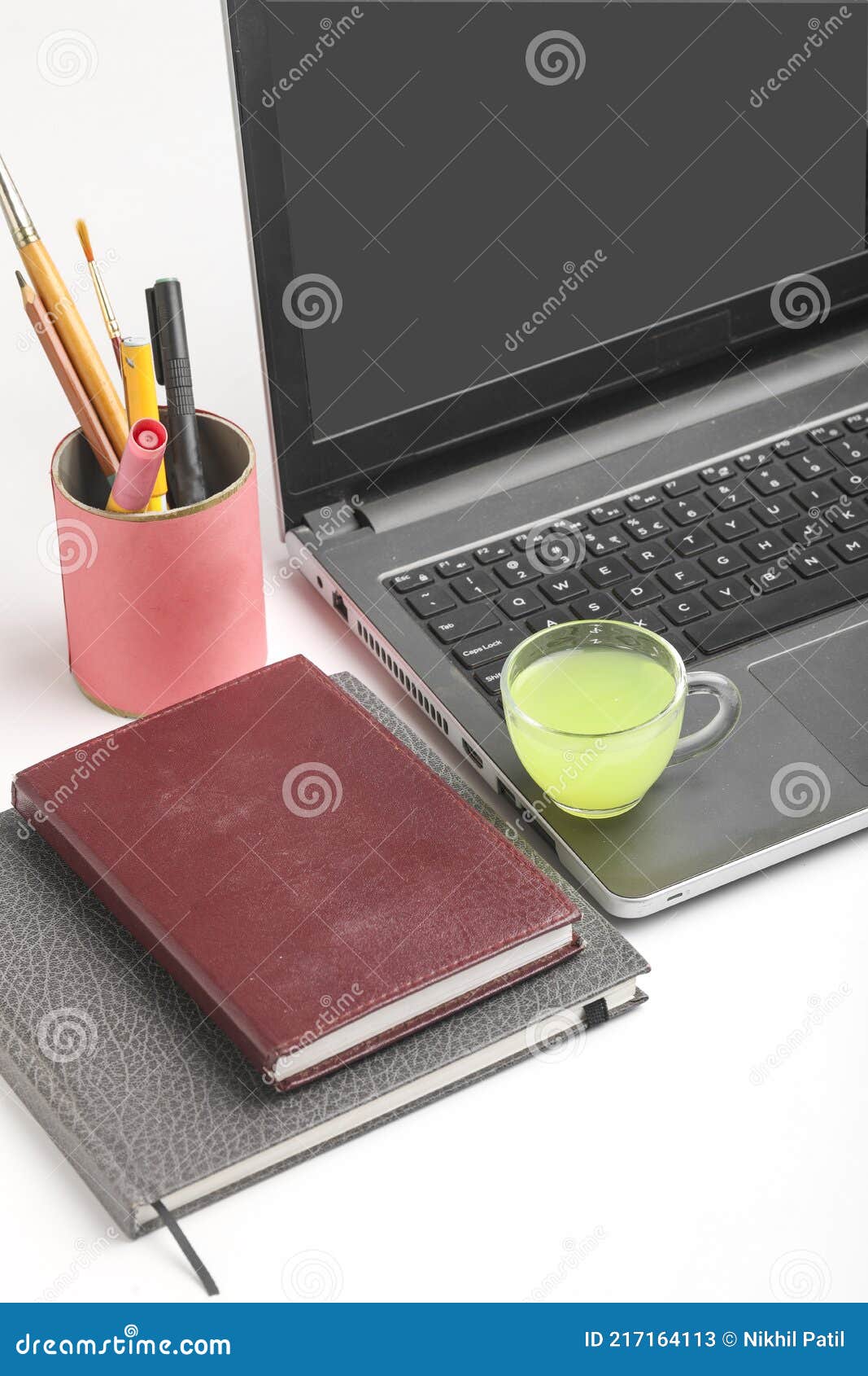 Laptop and Diary with Cup of Green Tea. Work from Home Concept Stock