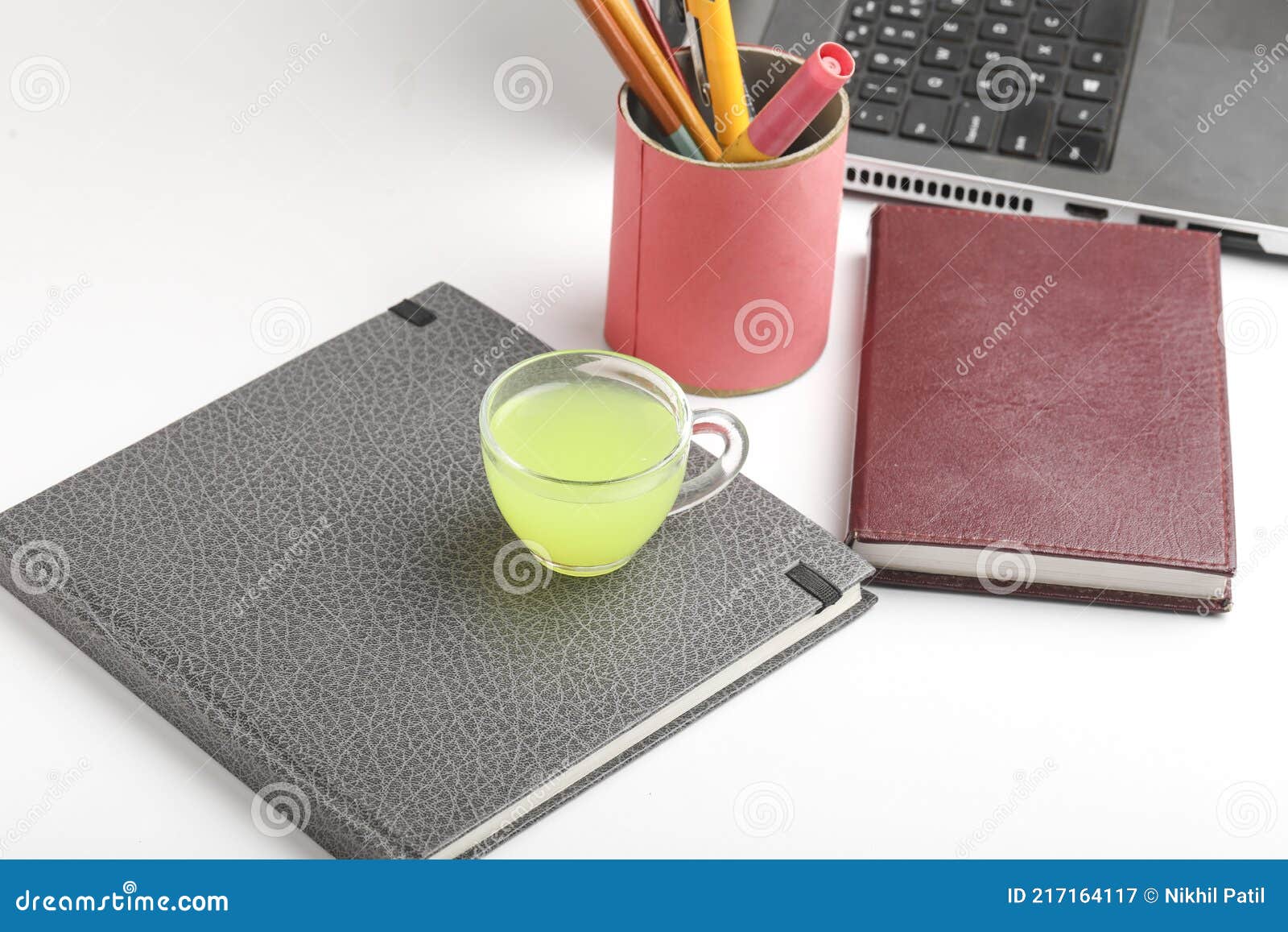 Laptop and Diary with Cup of Green Tea. Work from Home Concept Stock