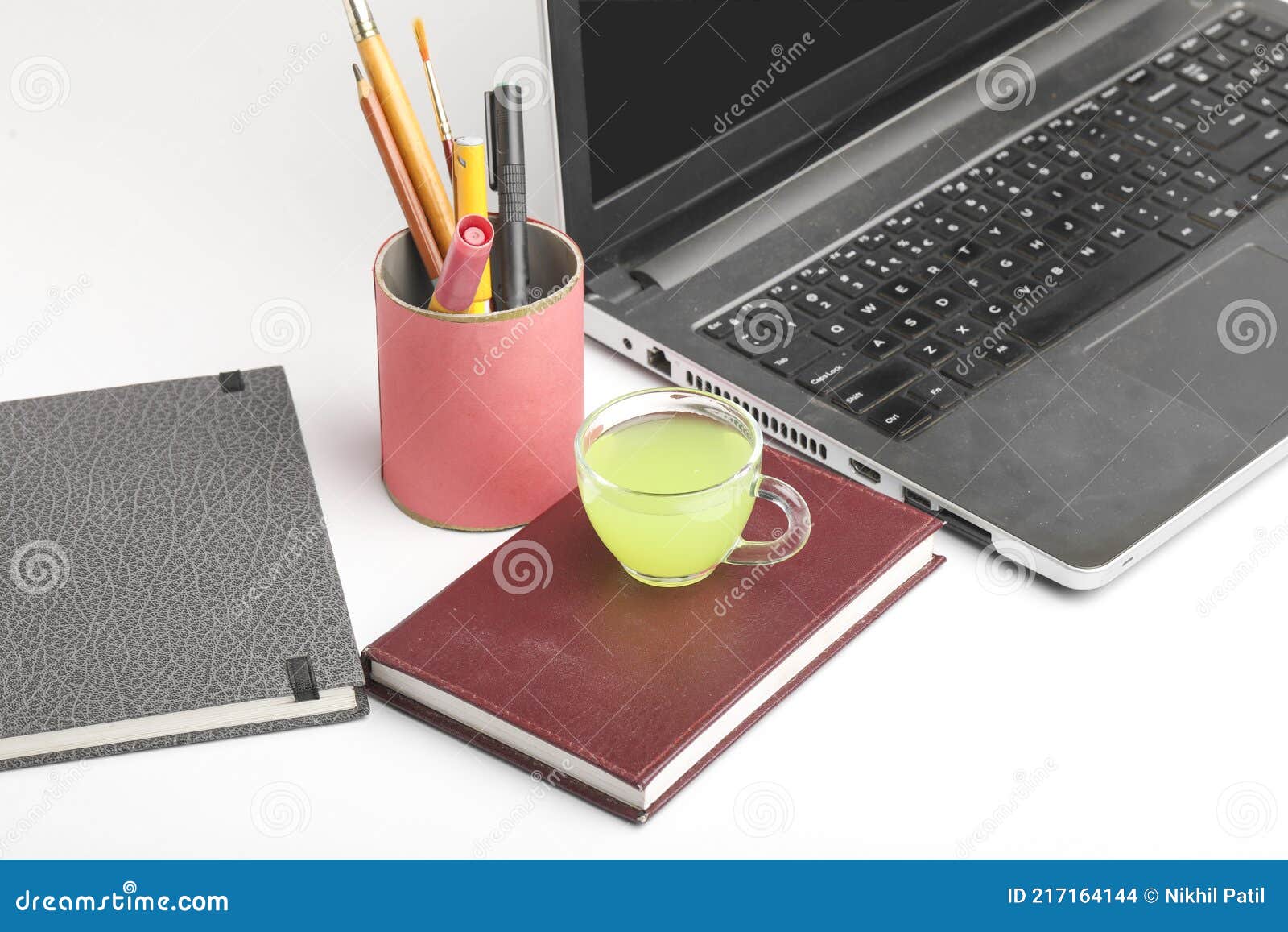 Laptop and Diary with Cup of Green Tea. Work from Home Concept Stock