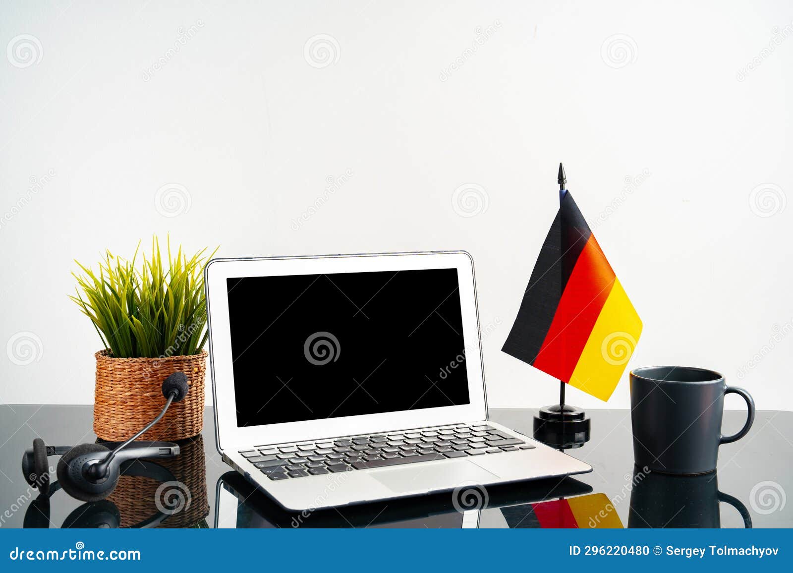 Laptop with German Flag on Working Table, Educational Concept Stock