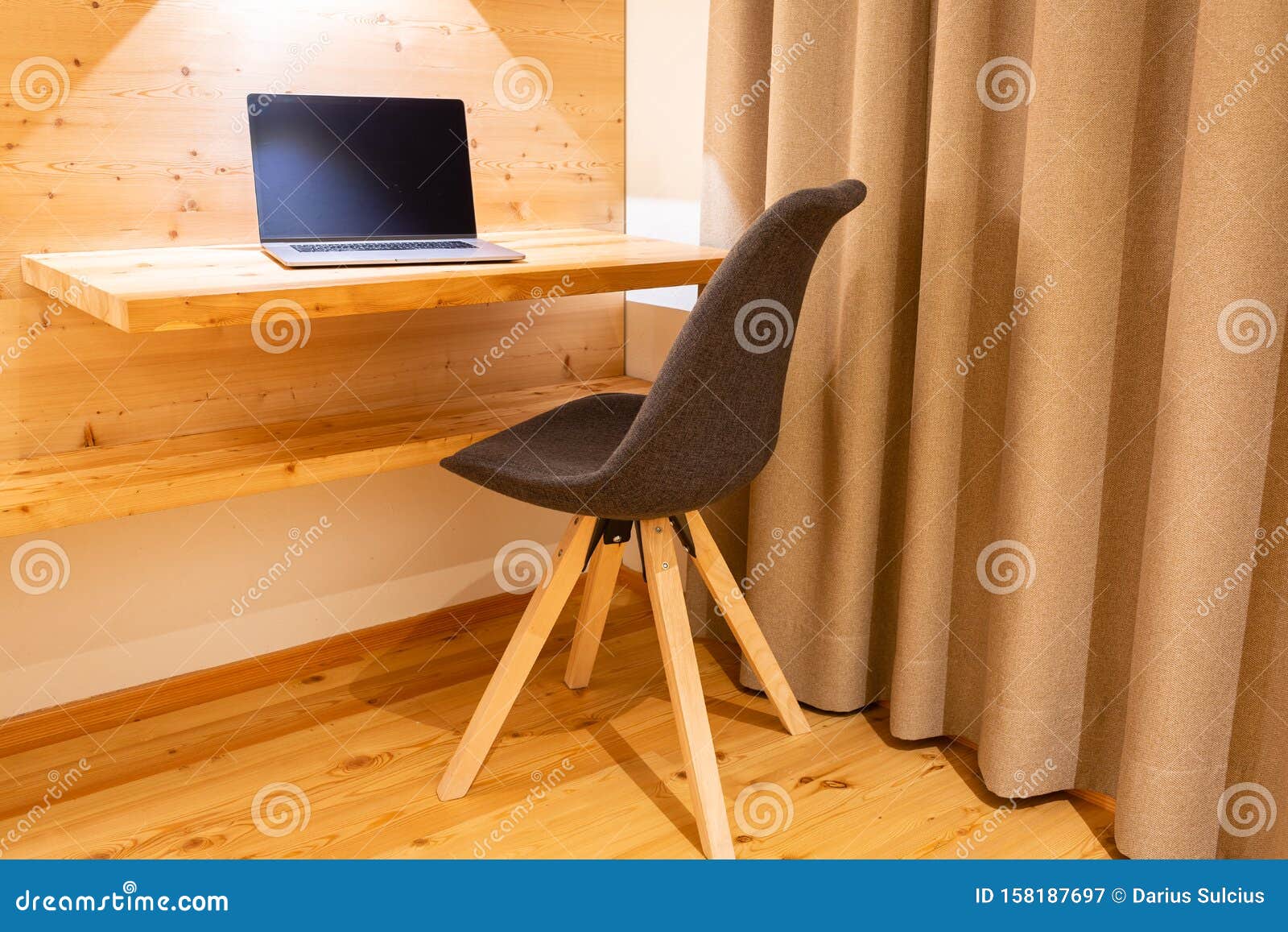 Laptop Placed On Wooden Wall Work Desk In Hotel Room Stock Image